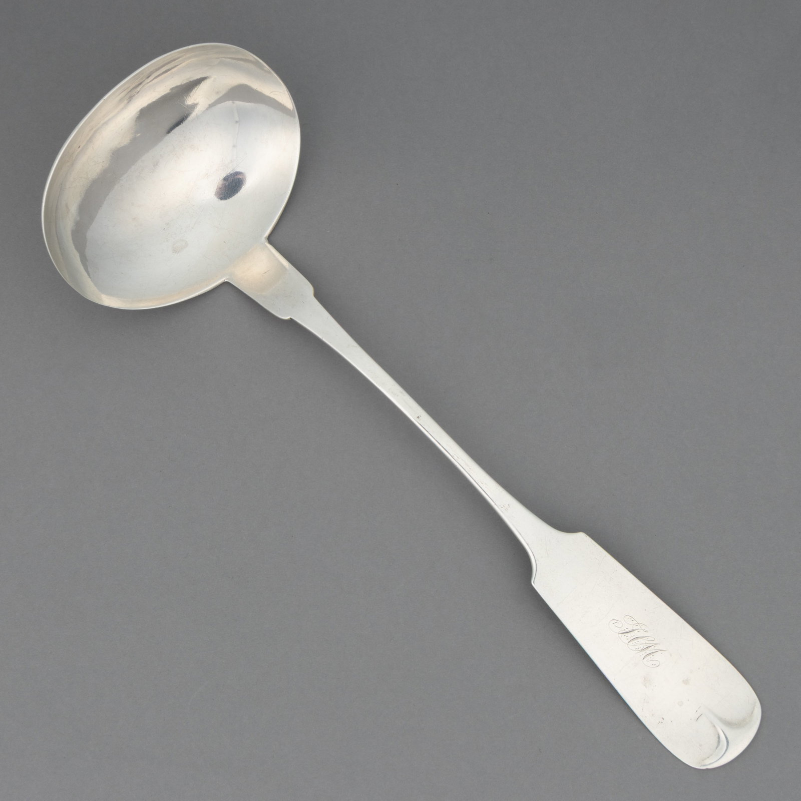 MITCHELL & TYLER, RICHMOND, VIRGINIA COIN SILVER PUNCH / SOUP LADLE: MITCHELL & TYLER, RICHMOND, VIRGINIA COIN SILVER PUNCH / SOUP LADLE, ovoid bowl on a forward-tipped fiddle handle with pointed shoulders and engraved "TCM [or JCM]" initials. Impres