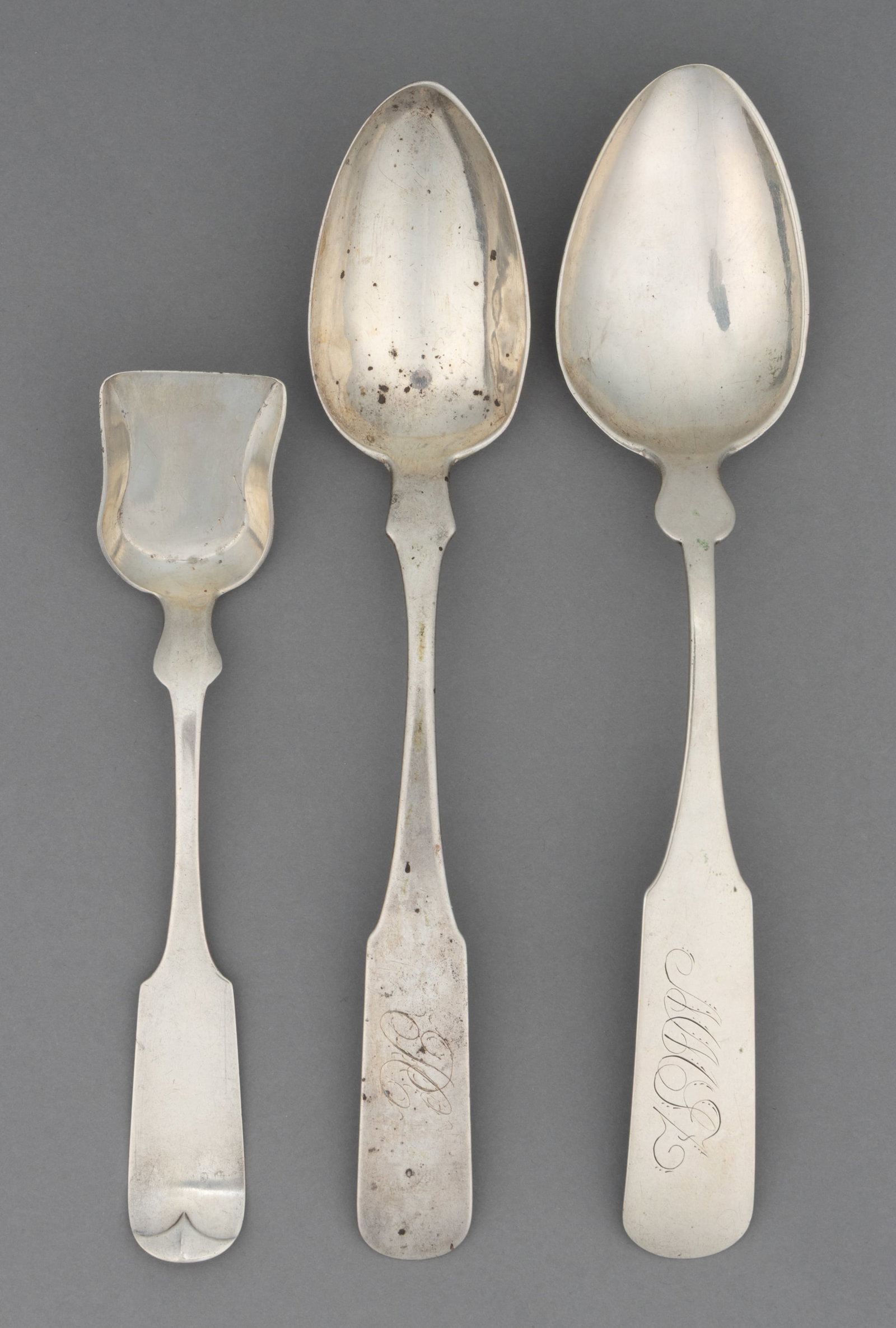 VIRGINIA AND NOW WEST VIRGINIA COIN SILVER SERVING SPOONS, LOT OF THREE: VIRGINIA AND NOW WEST VIRGINIA COIN SILVER SERVING SPOONS, LOT OF THREE, each with a fiddle handle with pointed shoulders; comprising a tablespoon by Joseph Clarico of Norfolk, VA (active c.1813-1828)