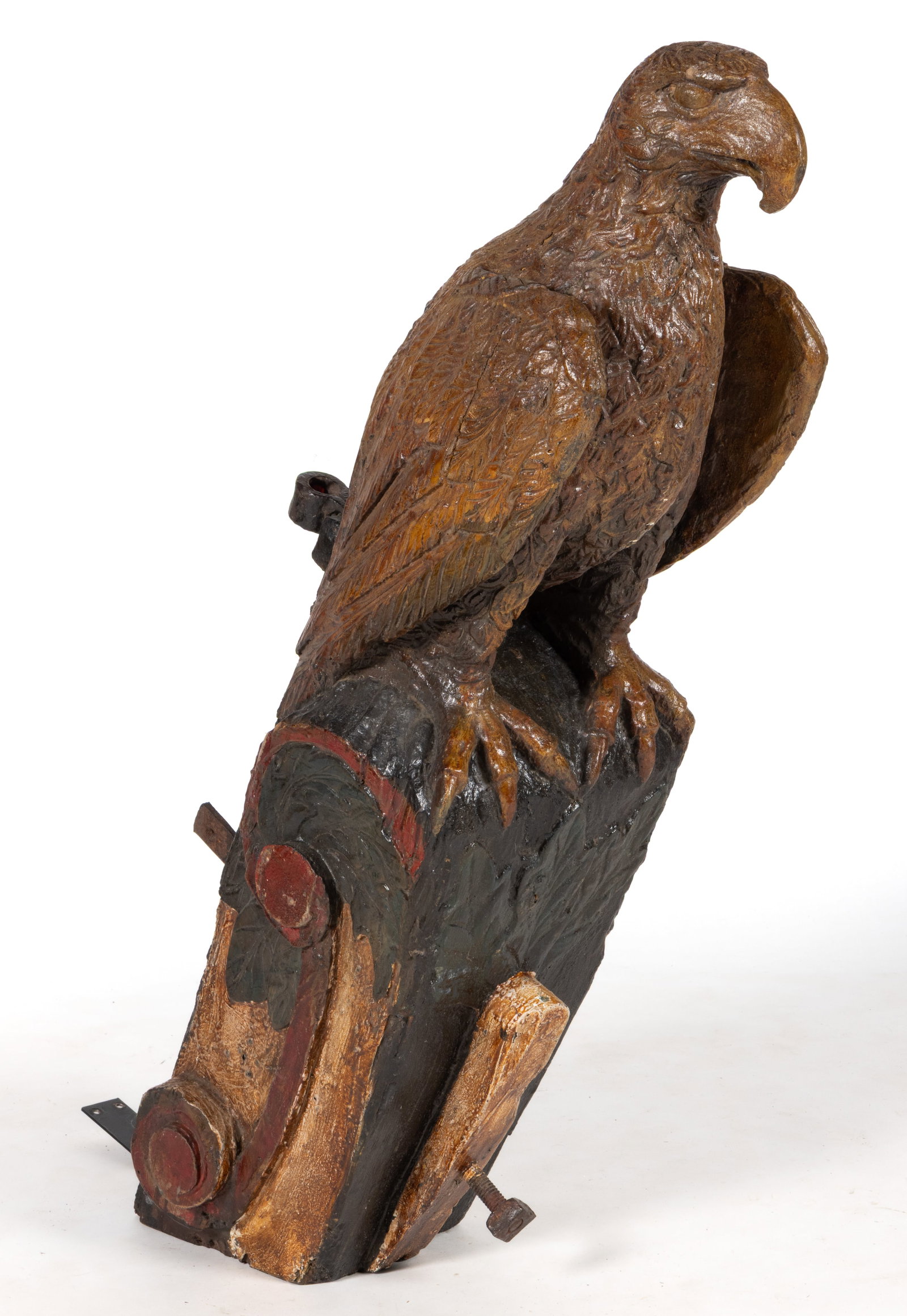 FOLK ART CARVED AND PAINTED WOODEN SHIP'S FIGUREHEAD: FOLK ART CARVED AND PAINTED WOODEN SHIP'S FIGUREHEAD, from the solid, depicting a bold eagle perched on a base with raised scrolls to each end. Retaining a later polychrome painted surface. 19th/2