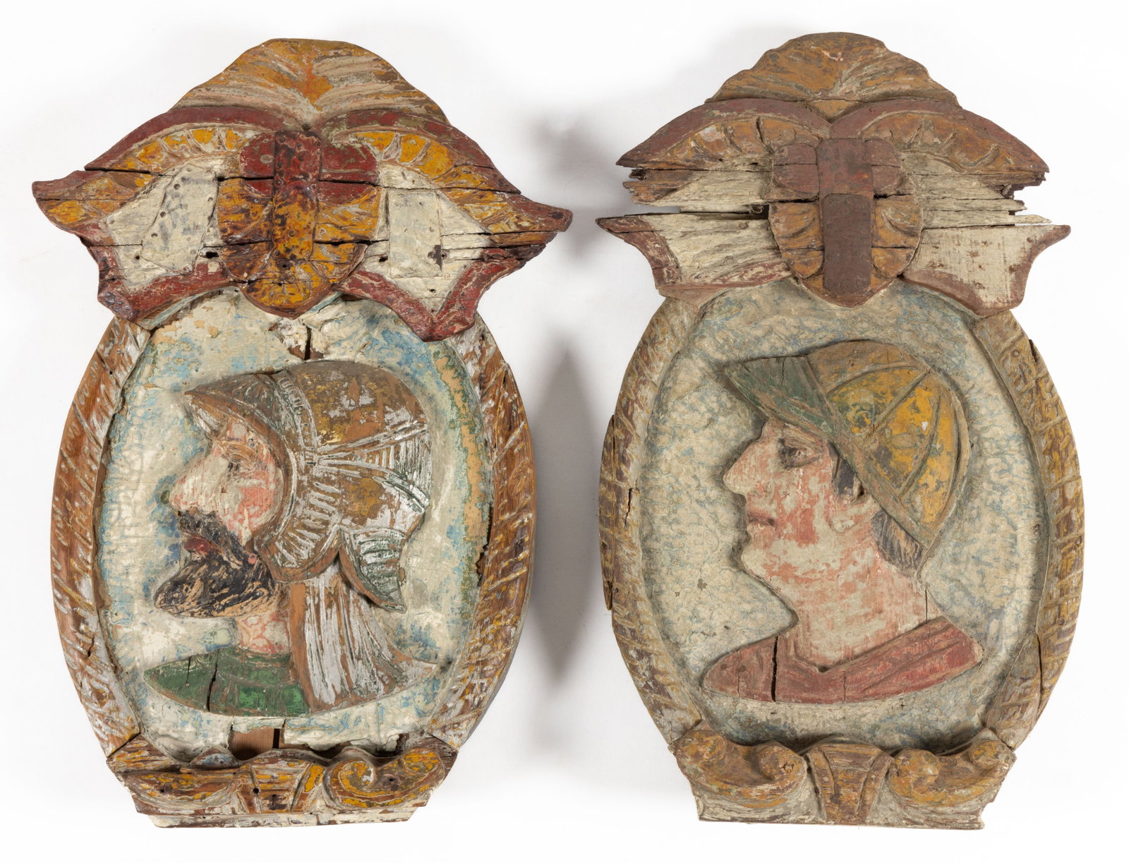 AMERICAN FOLK ART PAIR OF CARVED AND PAINTED CAROUSEL ROUNDING BOARDS: AMERICAN FOLK ART PAIR OF CARVED AND PAINTED CAROUSEL ROUNDING BOARDS, oval with central carving of a baseball player and a Roman soldier, both detailed with polychrome paint, a blue marbled back