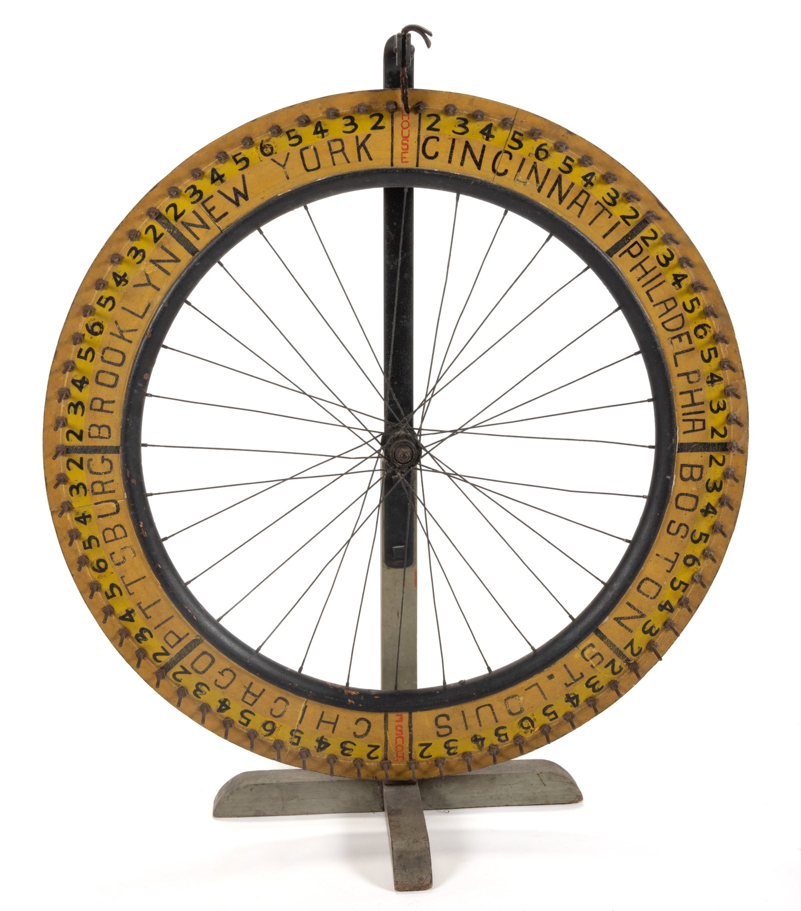 AMERICAN FOLK ART PAINTED WOODEN GAMING WHEEL: AMERICAN FOLK ART PAINTED WOODEN GAMING WHEEL, typical form with wooden frame attached to a bicycle wheel, featuring black numbers against a yellow ground, additional markings for "BROOKLYN / NEW
