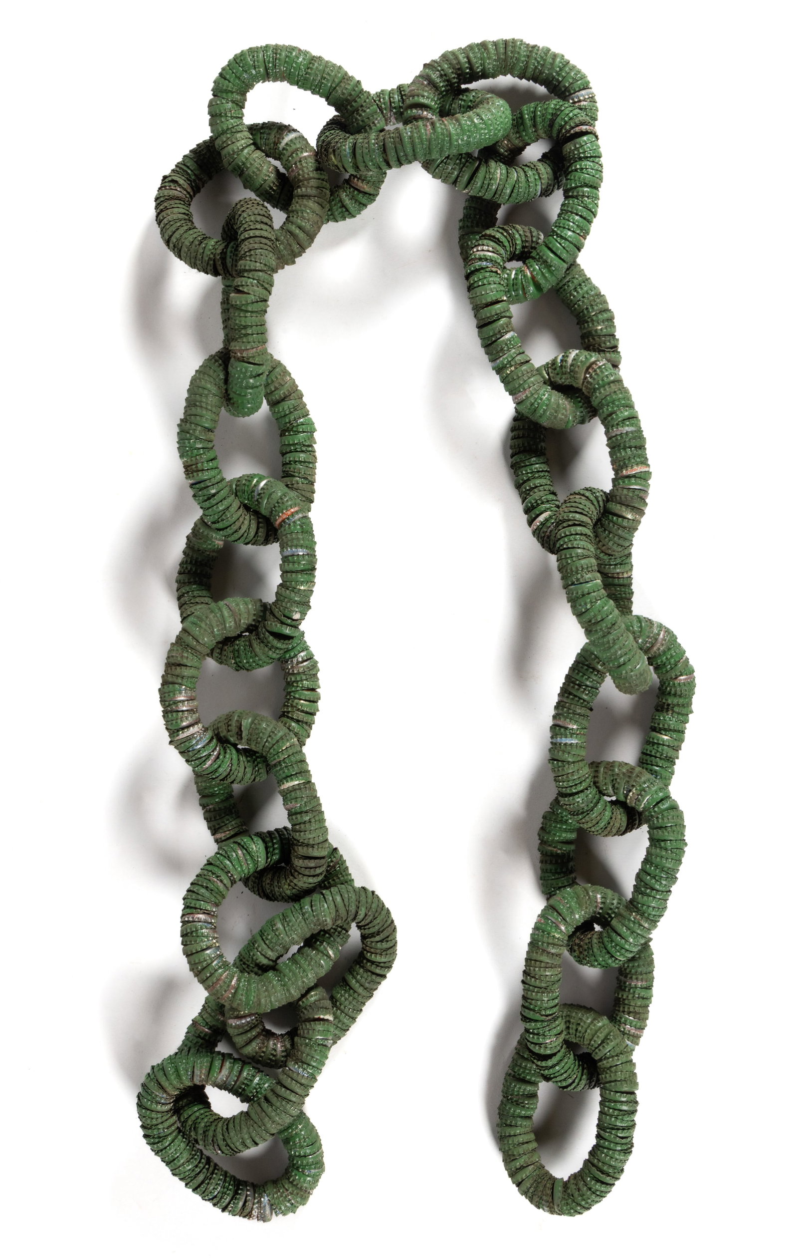 AMERICAN FOLK ART PAINTED BOTTLE-CAP CHAIN WHIMSY: AMERICAN FOLK ART PAINTED BOTTLE-CAP CHAIN WHIMSY, comprising 21 oval links, each made up of approximately 100 metal soda pop caps, including Pepsi, Mt. Dew, Dr. Pepper, etc. Retains its original gree