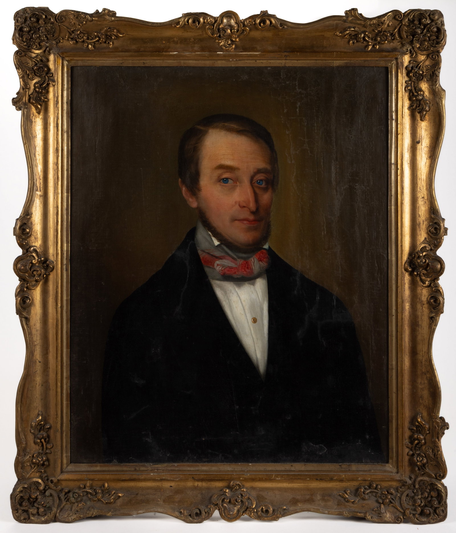 CONTINENTAL SCHOOL (19TH CENTURY) PORTRAIT OF A MAN: CONTINENTAL SCHOOL (19TH CENTURY) PORTRAIT OF A MAN, oil on canvas, bust-length depiction of a blue-eyed subject wearing black coat, high white stock and colorful bowtie, retaining a label attach