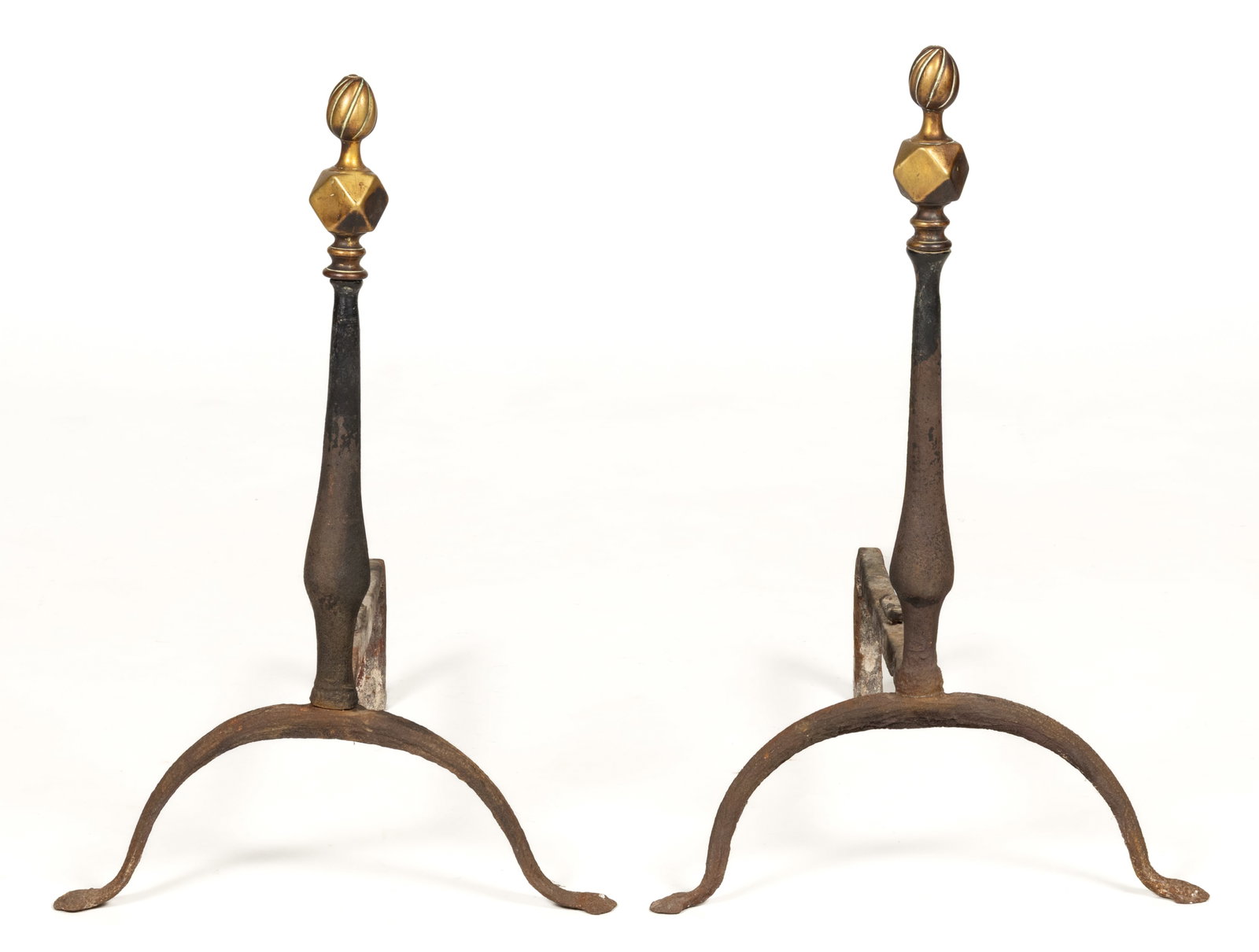 AMERICAN WROUGHT-IRON AND BRASS PAIR OF ANDIRONS: AMERICAN WROUGHT-IRON AND BRASS PAIR OF ANDIRONS, brass flamed/swirling rib finial over a faceted ball with a shaped baluster-form shaft, raised on arched legs terminating in penny-form