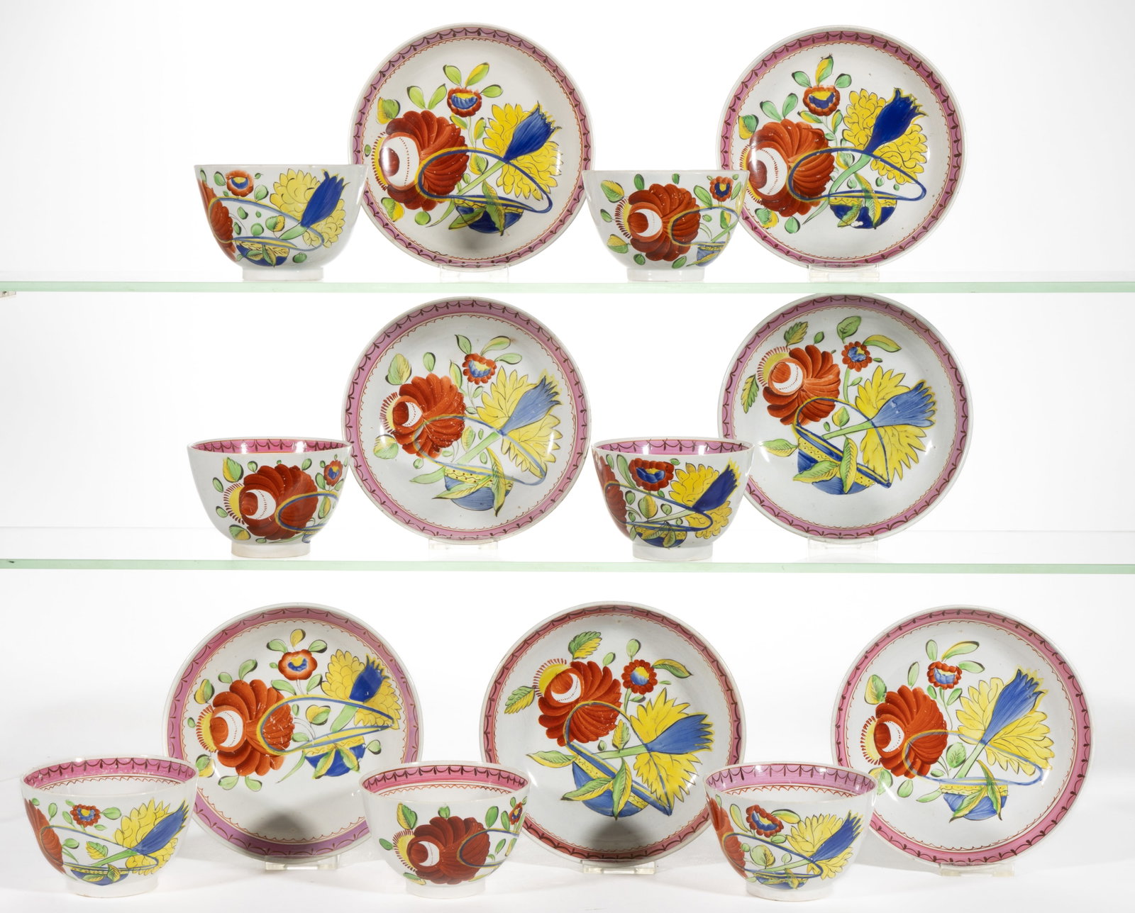 ENGLISH PEARLWARE KING'S ROSE OYSTER HAND-PAINTED CERAMIC CUP AND SAUCER SETS, LOT OF SEVEN: ENGLISH PEARLWARE KING'S ROSE OYSTER HAND-PAINTED CERAMIC CUP AND SAUCER SETS, LOT OF SEVEN, each having bold polychrome decoration featuring large flowers including yellow and blue examples and a