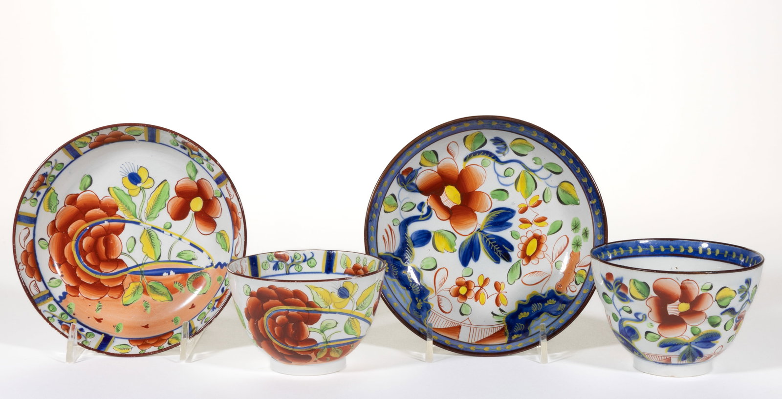 ENGLISH PEARLWARE HAND-PAINTED GAUDY DUTCH CERAMIC CUP AND SAUCER SETS, LOT OF TWO (1 of 2)