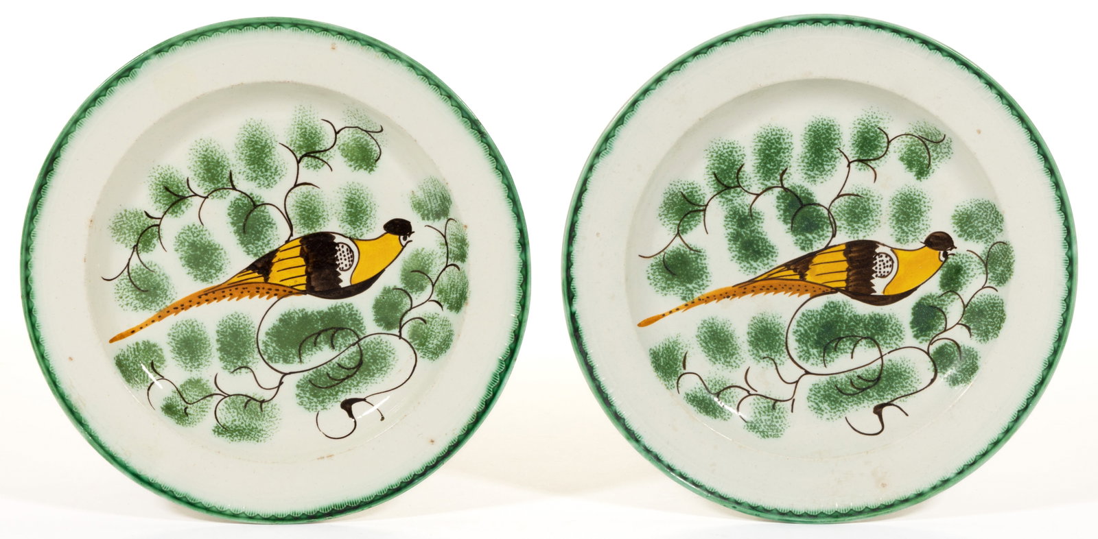 BRITISH PEARLWARE PEAFOWL MOTIF CERAMIC PLATES, LOT OF TWO: BRITISH PEARLWARE PEAFOWL MOTIF CERAMIC PLATES, LOT OF TWO, each featuring a polychrome hand-painted bird with helmet-like feathering to head and perched on a green-sponged tree branches, having green