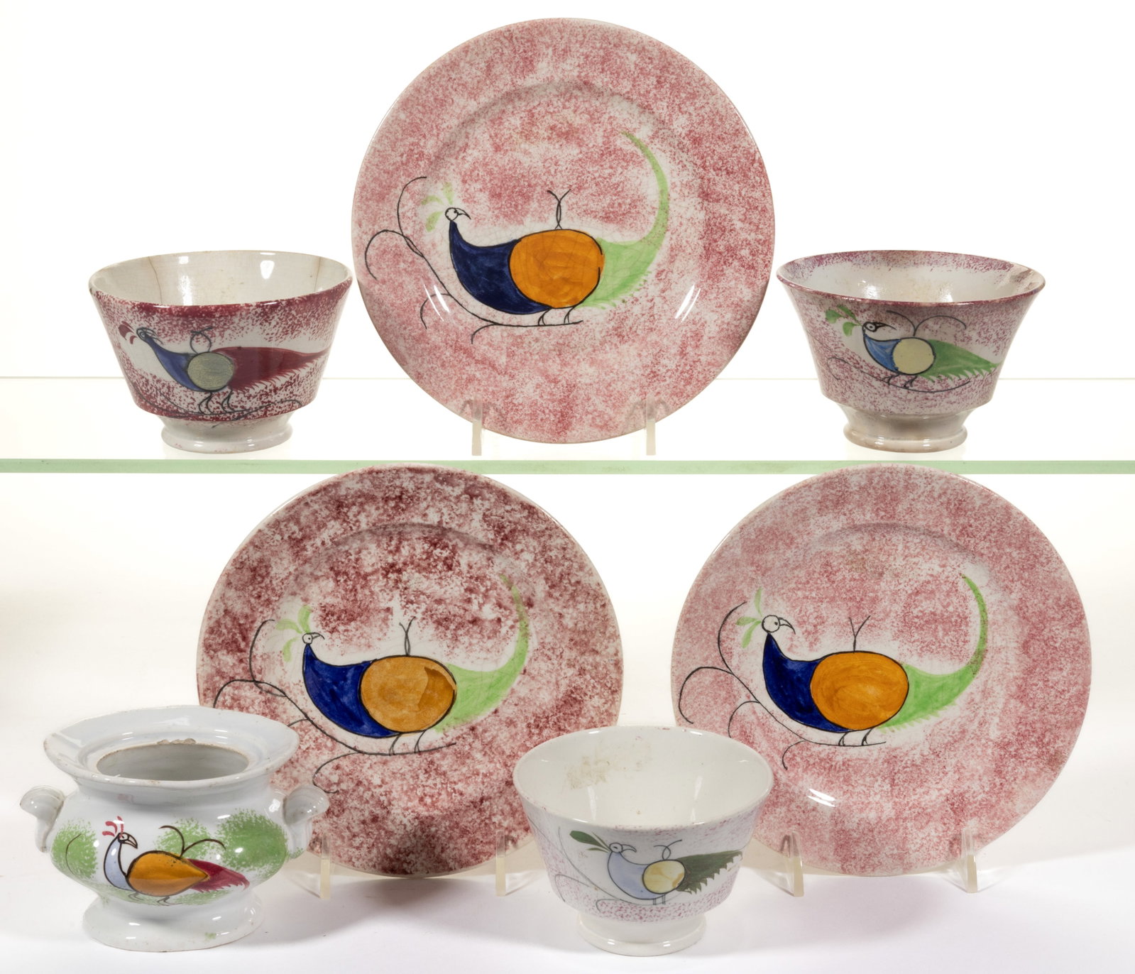 BRITISH SPATTERWARE HAND-PAINTED PEAFOWL MOTIF CERAMIC ARTICLES, LOT OF SEVEN: BRITISH SPATTERWARE HAND-PAINTED PEAFOWL MOTIF CERAMIC ARTICLES, LOT OF SEVEN, each featuring a polychrome long-tailed bird, comprising a children's toy soup tureen featuring additional green-spon