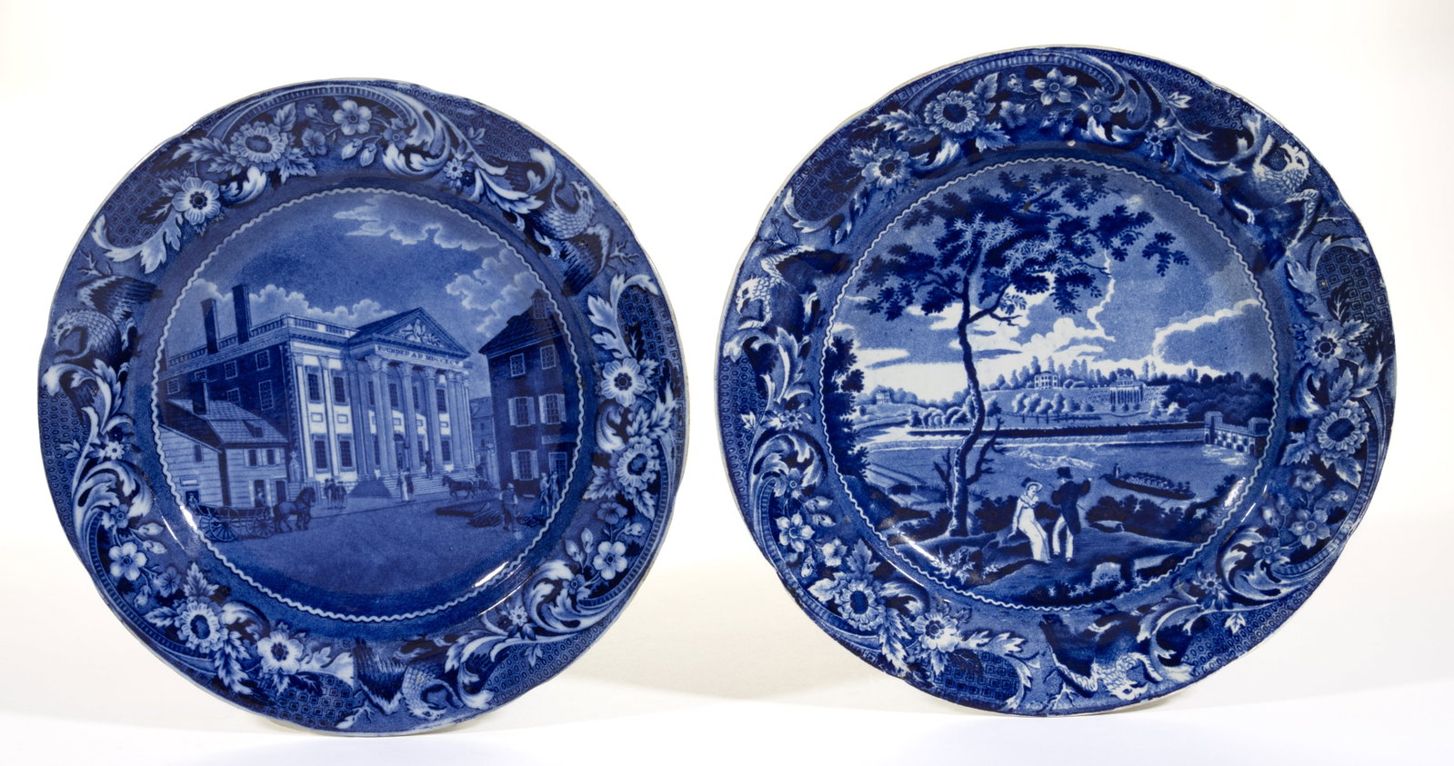 ENGLISH STAFFORDSHIRE AMERICAN VIEWS PHILADELPHIA, PENNSYLVANIA TRANSFER-PRINTED CERAMIC PLATES, LOT: ENGLISH STAFFORDSHIRE AMERICAN VIEWS PHILADELPHIA, PENNSYLVANIA TRANSFER-PRINTED CERAMIC PLATES, LOT OF TWO, each having dark blue transfer scenes with spread-wing eagle and scroll border decorat