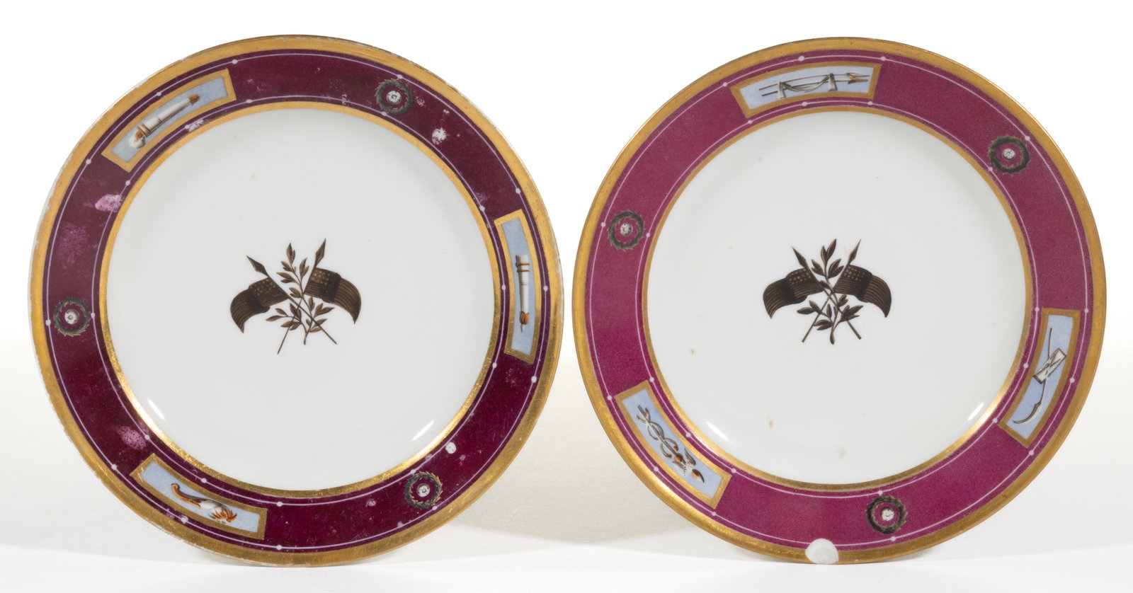 FRENCH PORCELAIN HAND-PAINTED AMERICAN MARKET PLATES, LOT OF TWO: FRENCH PORCELAIN HAND-PAINTED AMERICAN MARKET PLATES, LOT OF TWO, each featuring double-crossed American flags with olive branch to center and maroon and gilt border, comprising one example havin