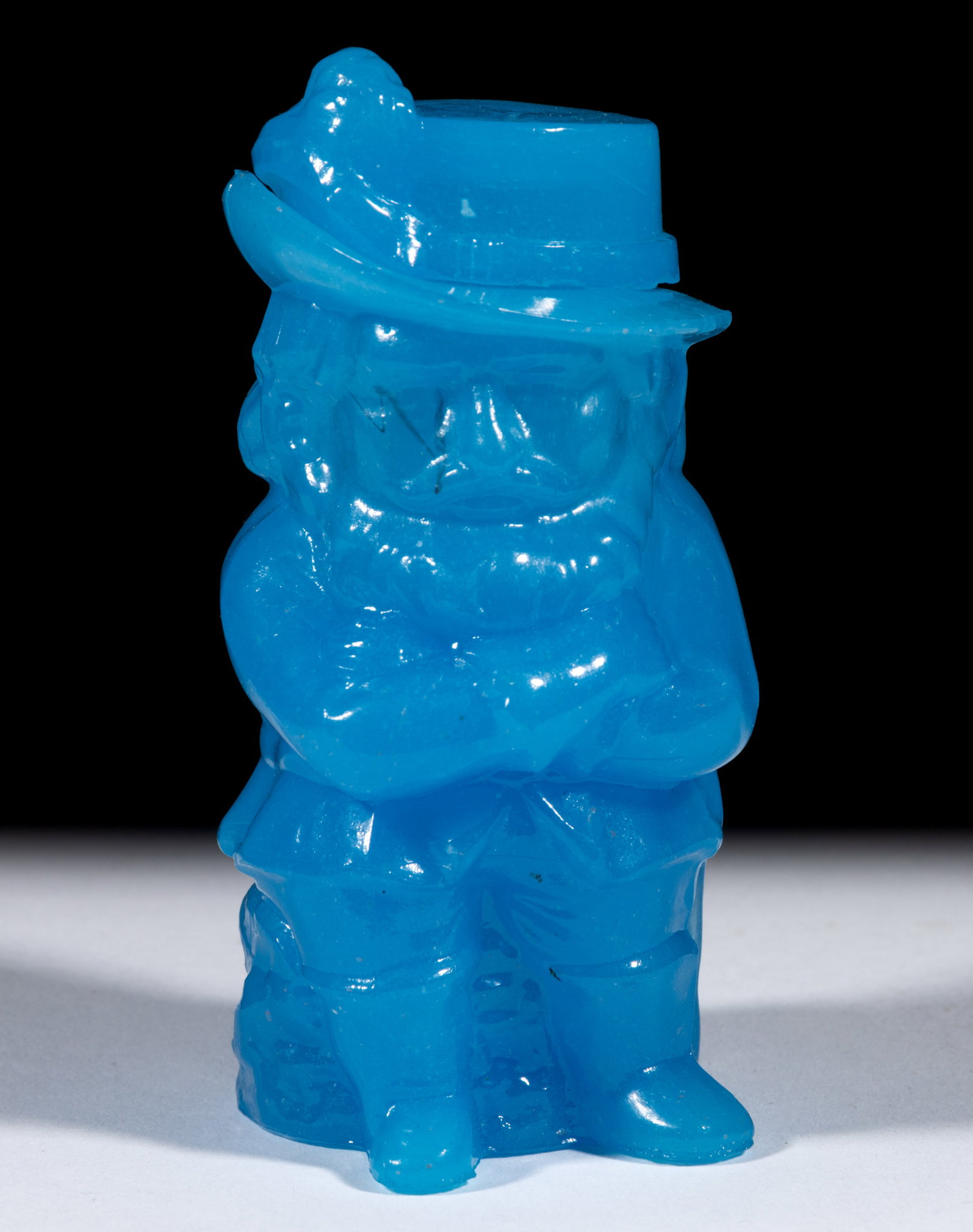 PRESSED CAVALIER POMADE JAR: PRESSED CAVALIER POMADE JAR, translucent starch blue, embossed "E. T. S & Co / NY" under base, crown of hat and plum form cover. Boston & Sandwich Glass Co. 1865-1868, when perfumer