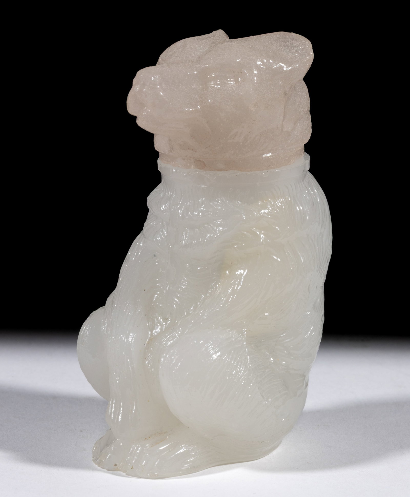 PRESSED CHAINED BEAR MEDIUM-SIZE JAR: PRESSED CHAINED BEAR MEDIUM-SIZE JAR, alabaster/clambroth, cover having a pink tint and lightly sanded surface, embossed "X. BAZIN / PHILA" under base. Boston & Sandwich Glass Co.