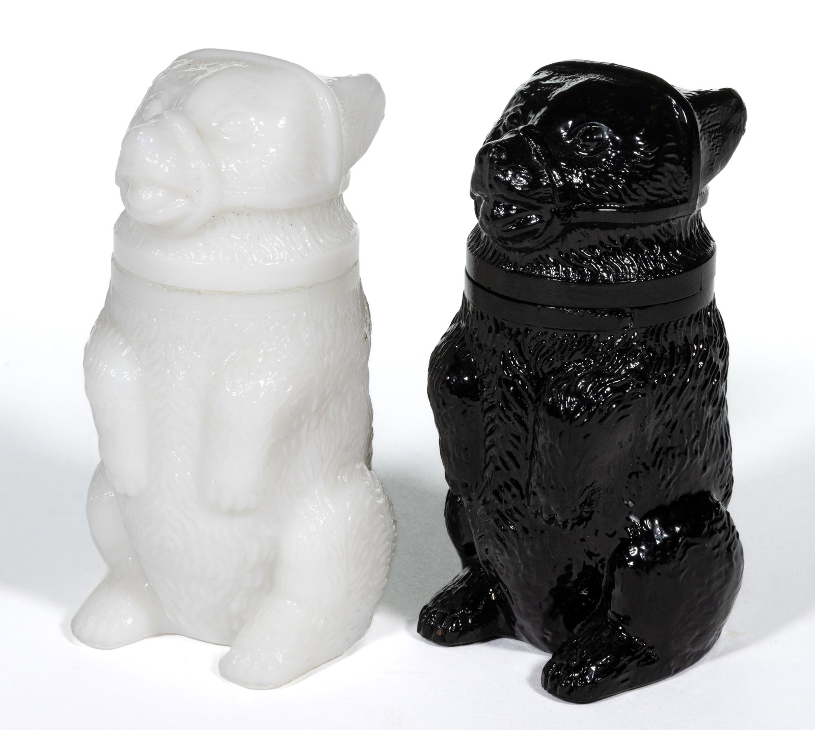 PRESSED MUZZLED BEAR SMALL-SIZE JARS, LOT OF TWO: PRESSED MUZZLED BEAR SMALL-SIZE JARS, LOT OF TWO, comprising an opaque white example with plain base, and an opaque black of deep amethyst example embossed "EUGENE BIZE & FRICKE /