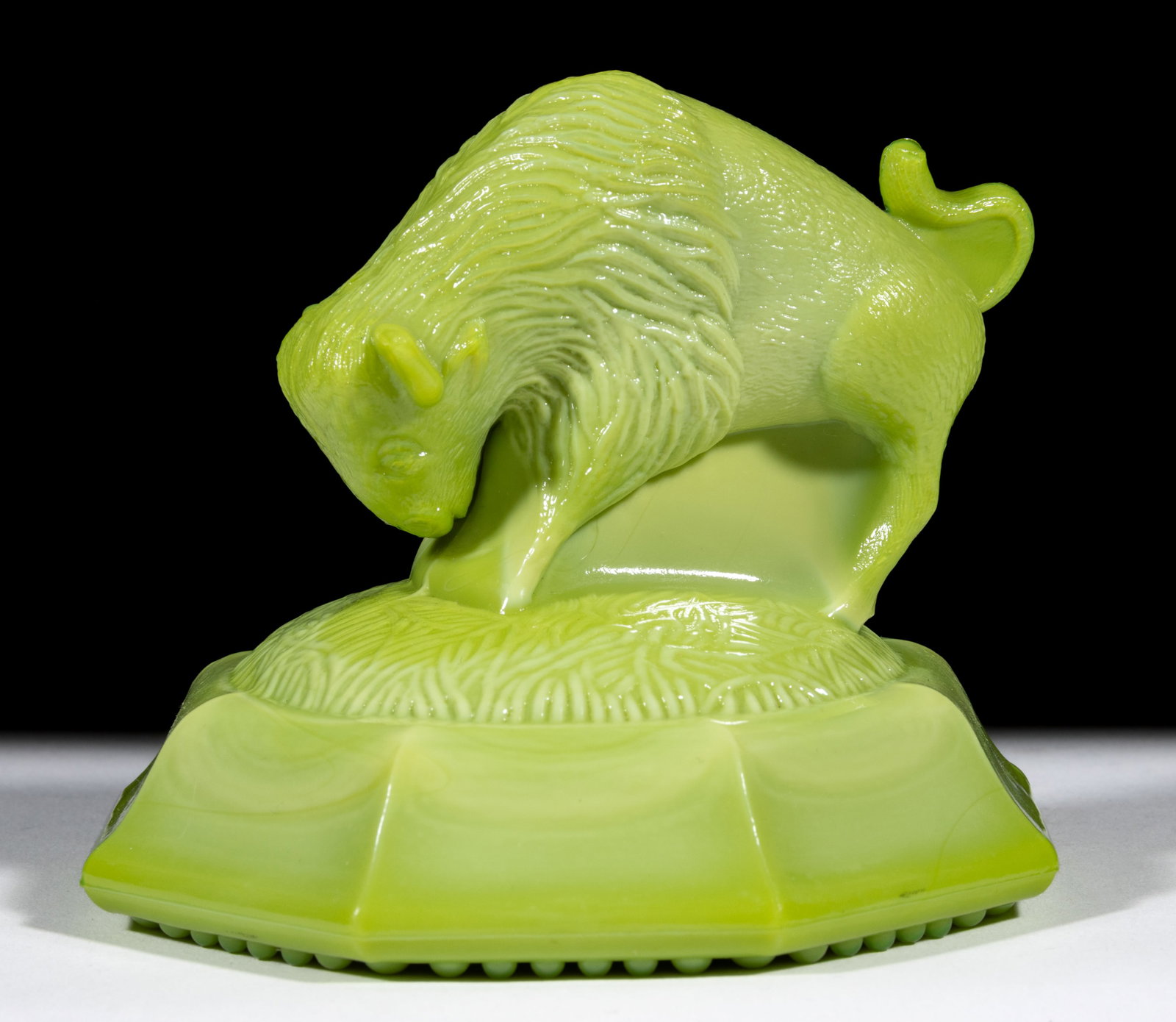 GREENTOWN BUFFALO PAPERWEIGHT: GREENTOWN BUFFALO PAPERWEIGHT, Nile Green, beaded rim base. Indiana Tumbler and Goblet Co., Greentown, IN. Pattern introduced in 1901. 3 1/4" HOA. Literature: Parallels NGGA - Greentown Glass, A 