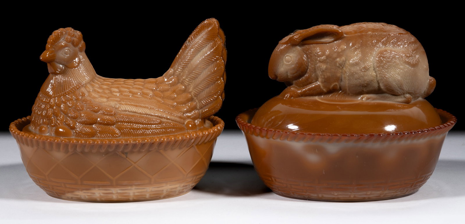 GREENTOWN ANIMAL COVERED DISHES, LOT OF TWO: GREENTOWN ANIMAL COVERED DISHES, LOT OF TWO, chocolate, comprising a rabbit and a hen, each with diamond and Basketweave base. Early 20th century. Indiana Tumbler & Goblet Co. Early 20th century. 