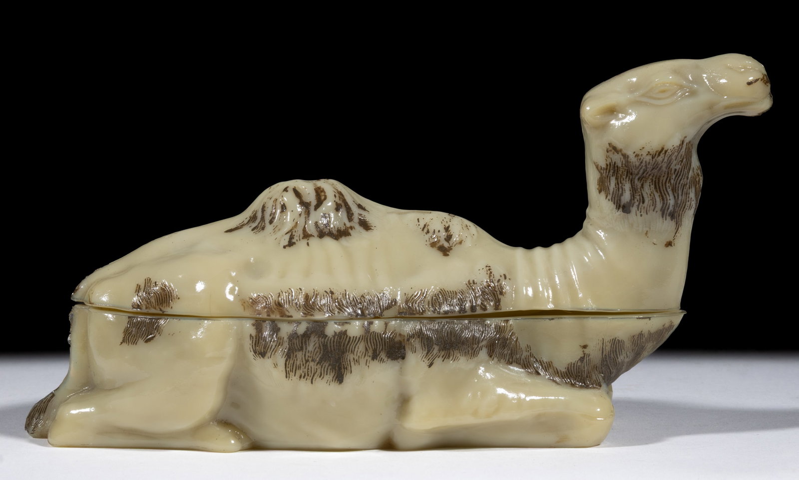 VALLERYSTHAL DROMEDARY CAMEL COVERED DISH: VALLERYSTHAL DROMEDARY CAMEL COVERED DISH, opaque caramel with original paint decoration, embossed "VALLERYSTHAL" on underside of base. First quarter 20th century. 4 1/4" HOA, 3" x