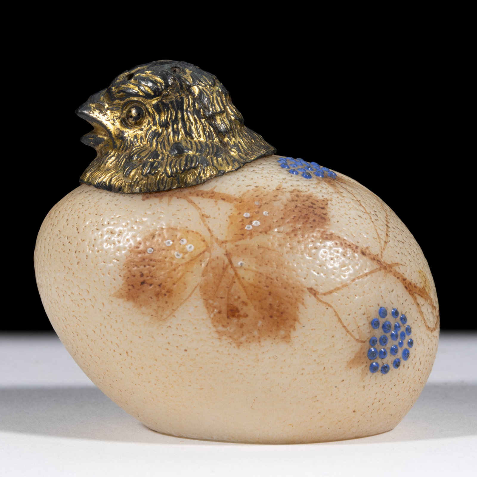 MT. WASHINGTON DECORATED OPAL CHICK HEAD GLASS SALT SHAKER: MT. WASHINGTON DECORATED OPAL CHICK HEAD GLASS SALT SHAKER, tan ground with polychrome floral decoration, original figural cover. Mt. Washington Glass Co. Circa 1894. 2 1/2" H. Literat