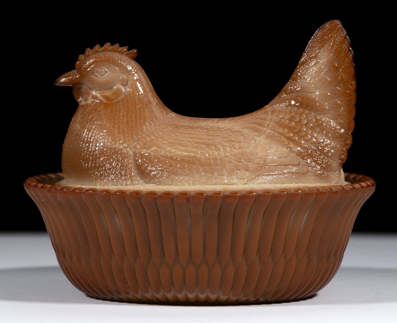 MCKEE HEN ON NEST COVERED DISH: MCKEE HEN ON NEST COVERED DISH, chocolate, split-rib base. McKee Glass Co. Early 20th century. 4 1/4" HOA, 4 1/4" x 5 1/2". Literature: Parallels NGGA/Measell (ed.) - Greentown Gla