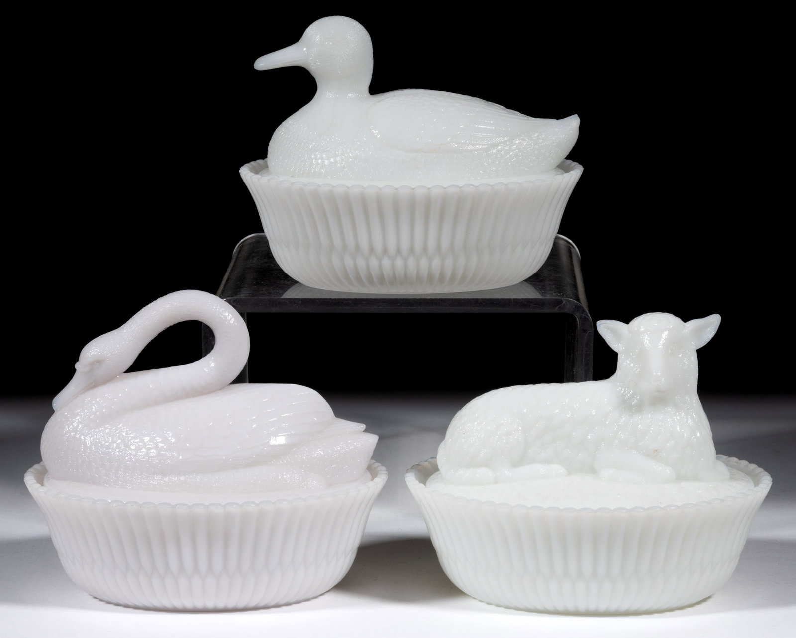 ASSORTED MCKEE NOVELTY FIGURAL ANIMAL COVERED DISHES, LOT OF THREE: ASSORTED MCKEE NOVELTY FIGURAL ANIMAL COVERED DISHES, LOT OF THREE, opaque white/milk glass, comprising a duck, lamb, and swan, each with split-rib base, each marked "McKEE" to the