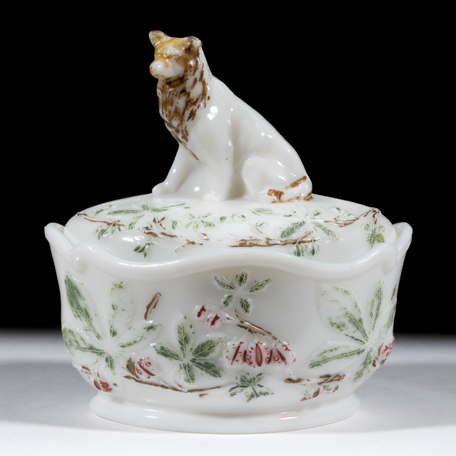 WOLF-DOG COVERED DISH: WOLF-DOG COVERED DISH, opaque white/milk glass with original paint decoration, oval dish and cover with strawberries and leaves embossed on the surface to the front of the animal. Maker unverifie
