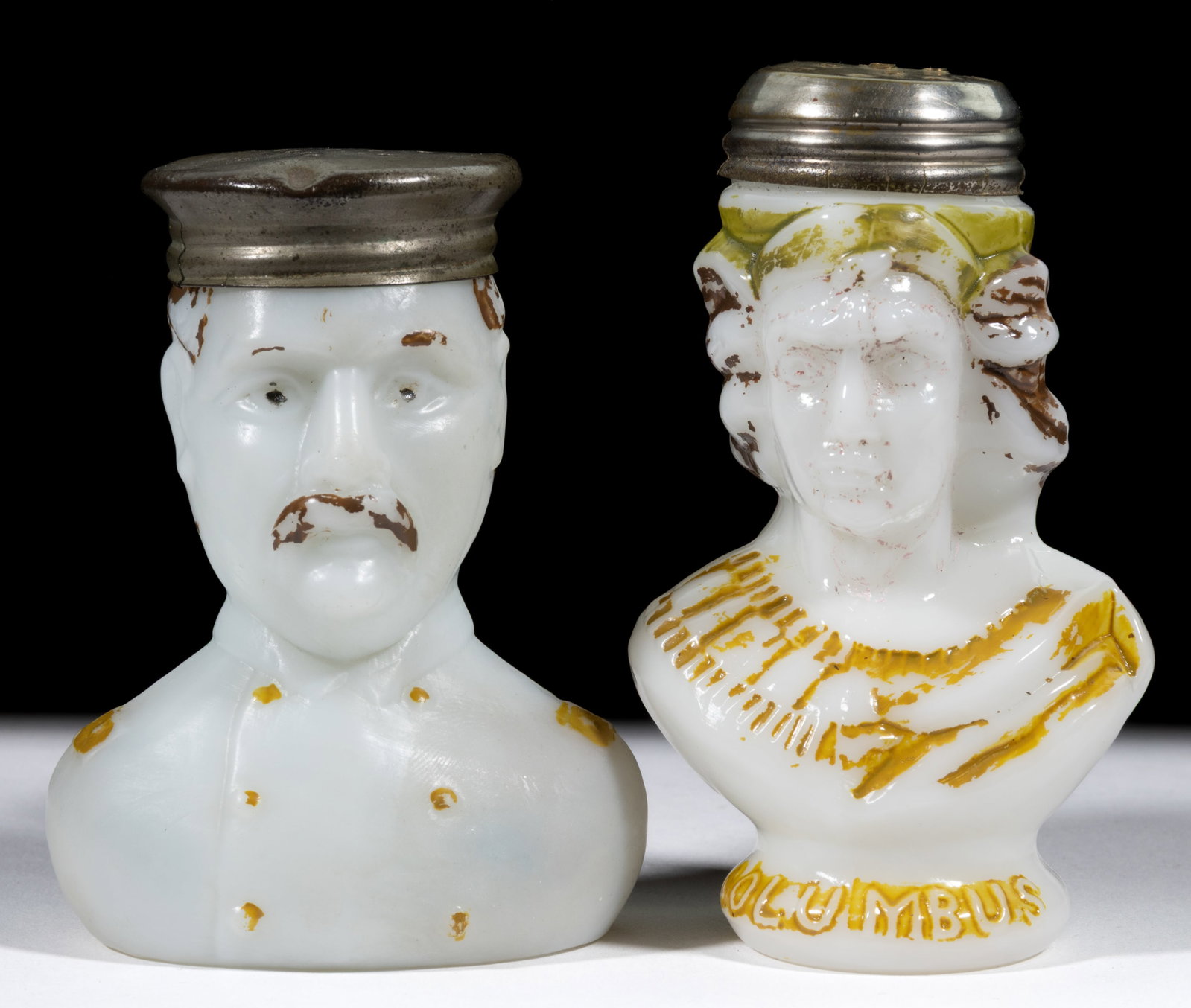 NOVELTY FIGURAL MILK GLASS SALT SHAKERS, LOT OF TWO: NOVELTY FIGURAL MILK GLASS SALT SHAKERS, LOT OF TWO, opaque white/milk glass with original paint decoration, comprising a Fitzhugh Lee and a Young Columbus example, embossed around the 