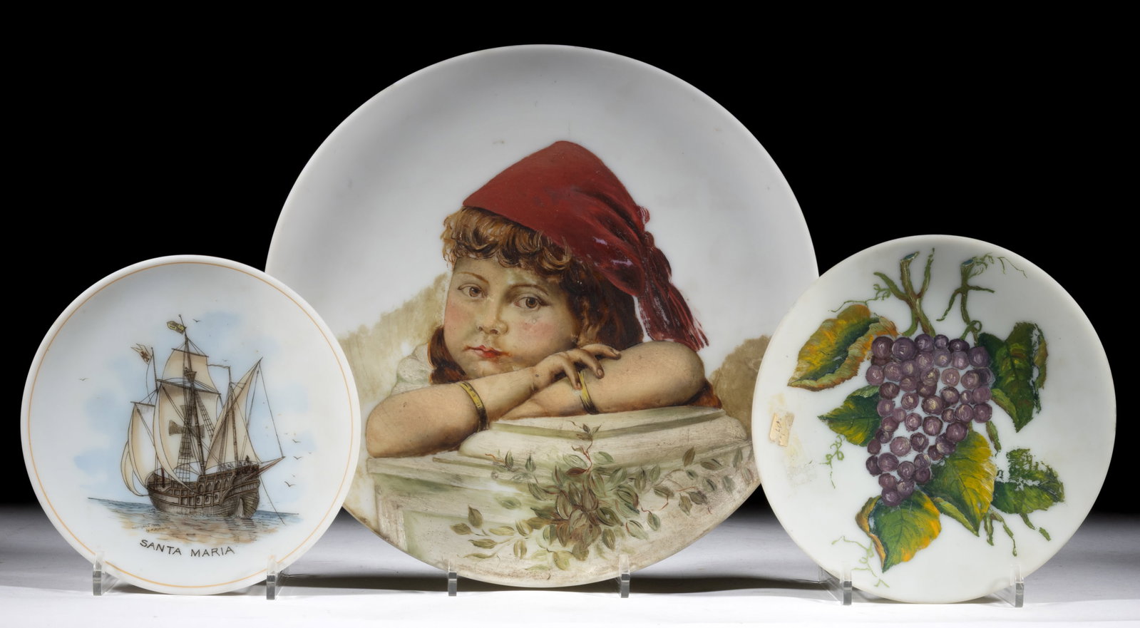 LIBBEY AND OTHER DECORATED OPAL GLASS PLATES, LOT OF THREE: LIBBEY AND OTHER DECORATED OPAL GLASS PLATES, LOT OF THREE, opaque white with plush finish, comprising a hand-painted depiction of the "SANTA MARIA", inscribed "Copyrighted 1893/by A.E.