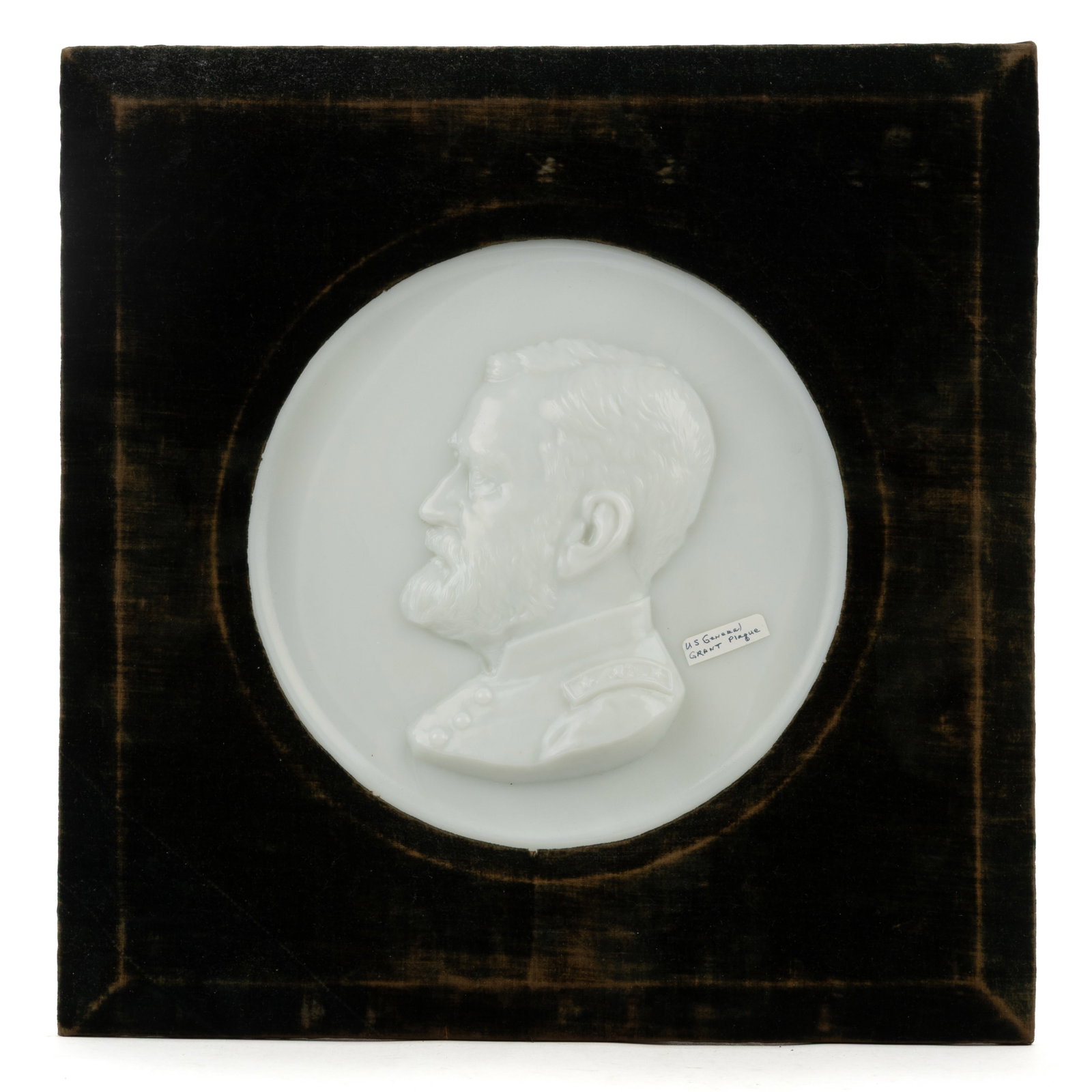 GENERAL ULYSSES S. GRANT PLAQUE: GENERAL ULYSSES S. GRANT PLAQUE, opaque white/milk glass, fitted into a velvet covered wooden frame, probably original. Maker unverified. Fourth quarter 19th century. Plaque 10 1/2" D, frame 16 3