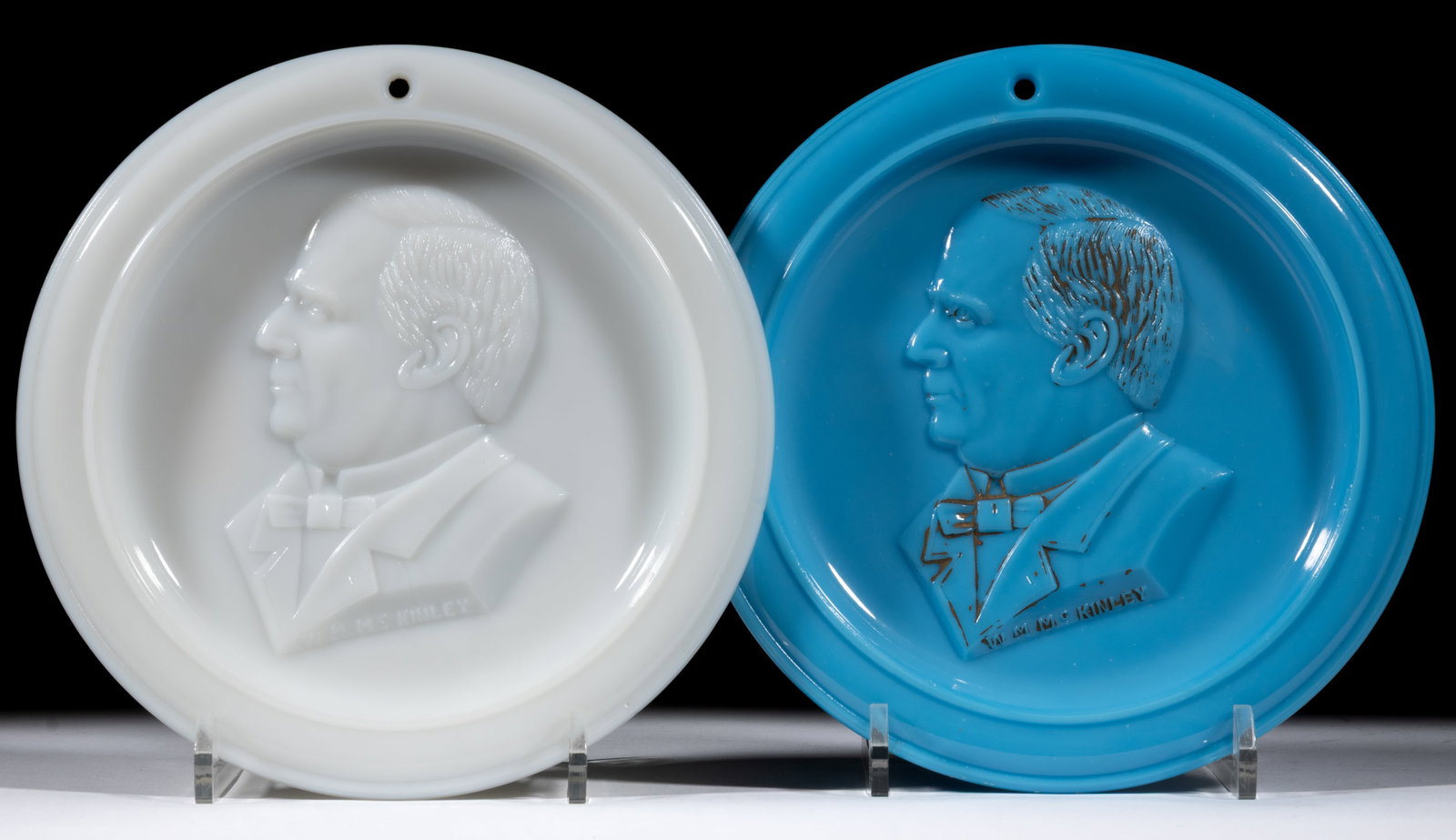 WILLIAM MCKINLEY PRESSED HISTORICAL GLASS HANGING PLATES / PLAQUES, LOT OF TWO: WILLIAM MCKINLEY PRESSED HISTORICAL GLASS HANGING PLATES / PLAQUES, LOT OF TWO, opaque white and opaque blue with original paint decoration, each having a matching side profile of President McKinley a