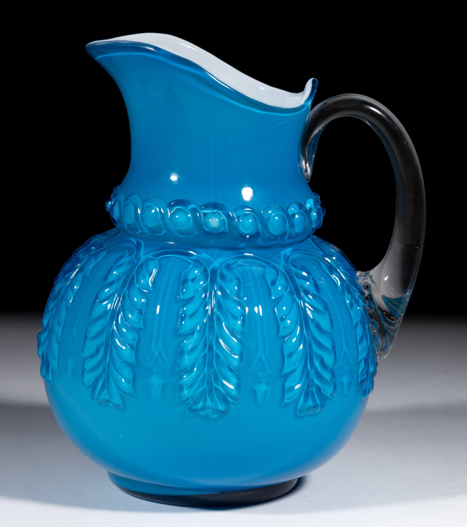 NORTHWOOD NO. 263 / LEAF UMBRELLA WATER PITCHER: NORTHWOOD NO. 263 / LEAF UMBRELLA WATER PITCHER, Turquoise, applied colorless handle. H. Northwood Glass Co. Pattern introduced in 1889. 9" H. Literature: Parallels Heacock/Measell/Wiggins - Harr