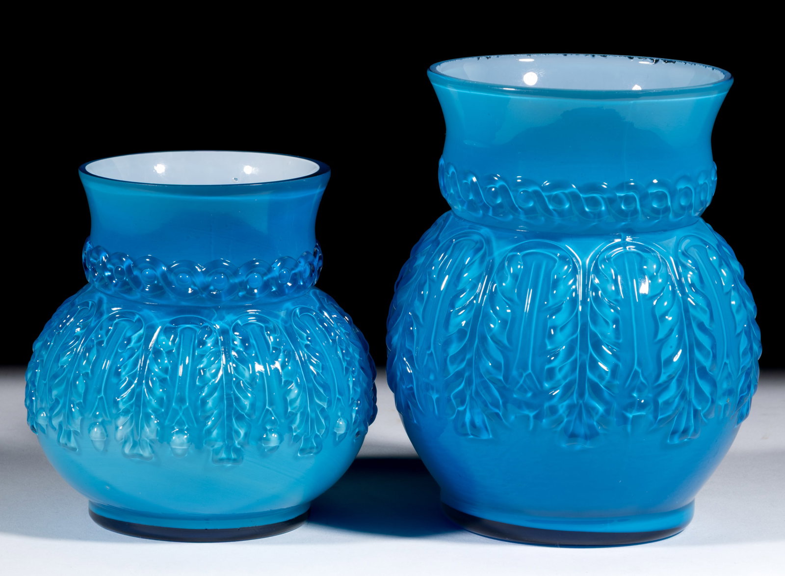 NORTHWOOD NO. 263 / LEAF UMBRELLA TABLE ARTICLES, LOT OF TWO: NORTHWOOD NO. 263 / LEAF UMBRELLA TABLE ARTICLES, LOT OF TWO, Turquoise, comprising a spooner and celery vase, both with factory polished rim. H. Northwood Glass Co. Pattern introduced in 1889. 4 1/4&