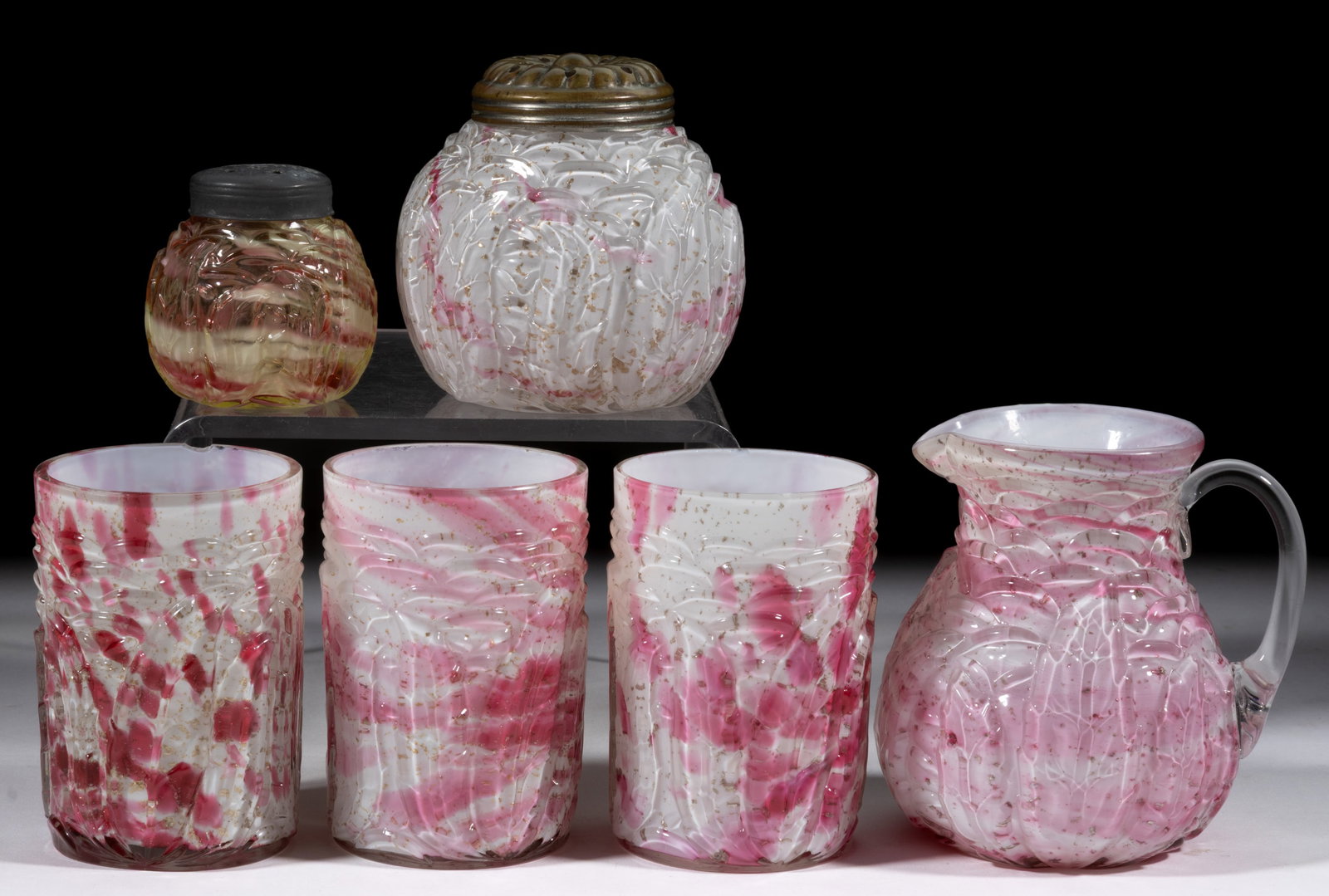 NORTHWOOD NO. 333 / LEAF MOLD GLASS ARTICLES, LOT OF SIX: NORTHWOOD NO. 333 / LEAF MOLD GLASS ARTICLES, LOT OF SIX, comprising one Vaseline (reacts under black light), splatter salt/pepper shaker, one sugar shaker, cased cranberry swirl with mica flakes, one