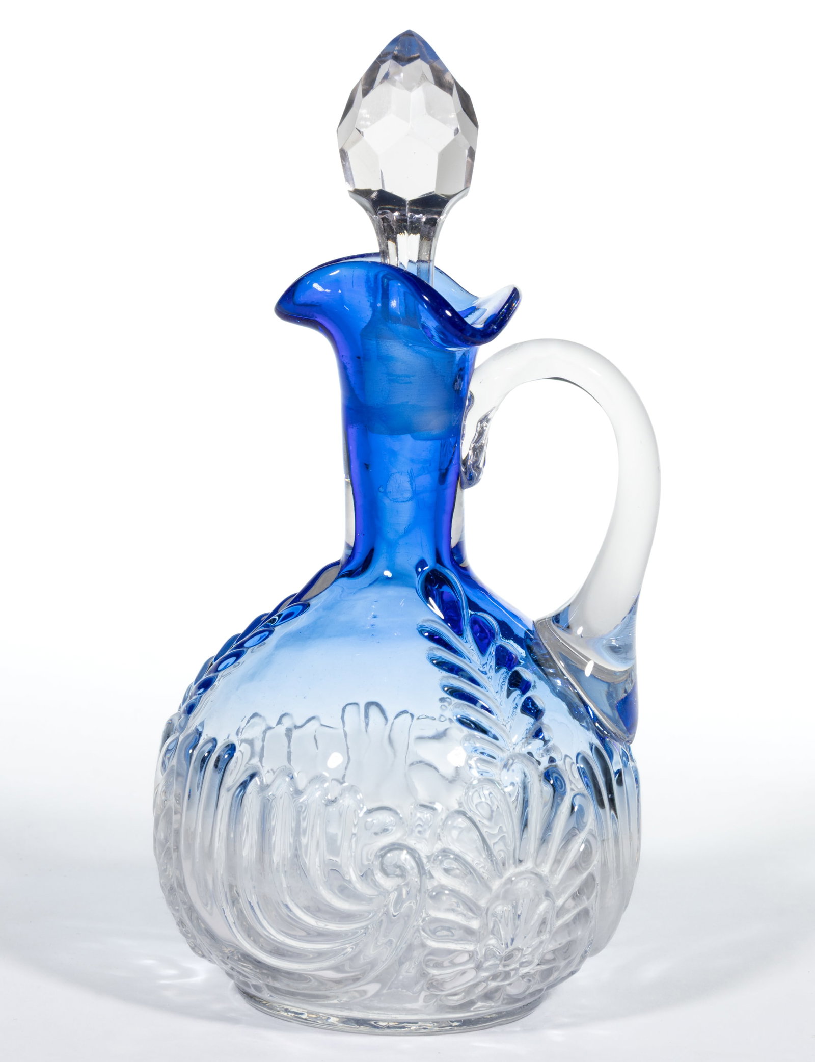 MEDALLION SPRIG CRUET: MEDALLION SPRIG CRUET, blue shaded to colorless, tri-fold spout, colorless applied handle, and cut-faceted stopper. West Virginia Glass Co. Circa 1894. 7 1/4" HOA. Literature: Parallels Heacock -