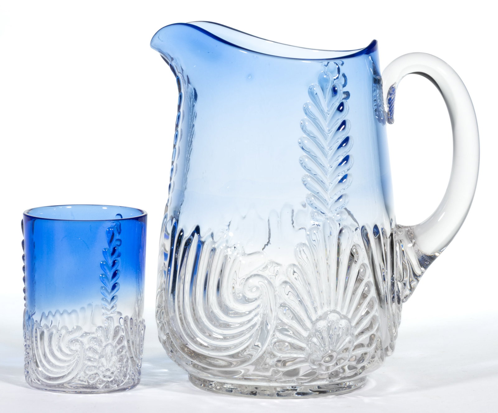 MEDALLION SPRIG WATER PITCHER AND TUMBLER, LOT OF TWO: MEDALLION SPRIG WATER PITCHER AND TUMBLER, LOT OF TWO, blue shaded to colorless, pitcher with applied handle with pressed fan design to the upper terminal. West Virginia Glass Co. Circa 1894. Pitcher: