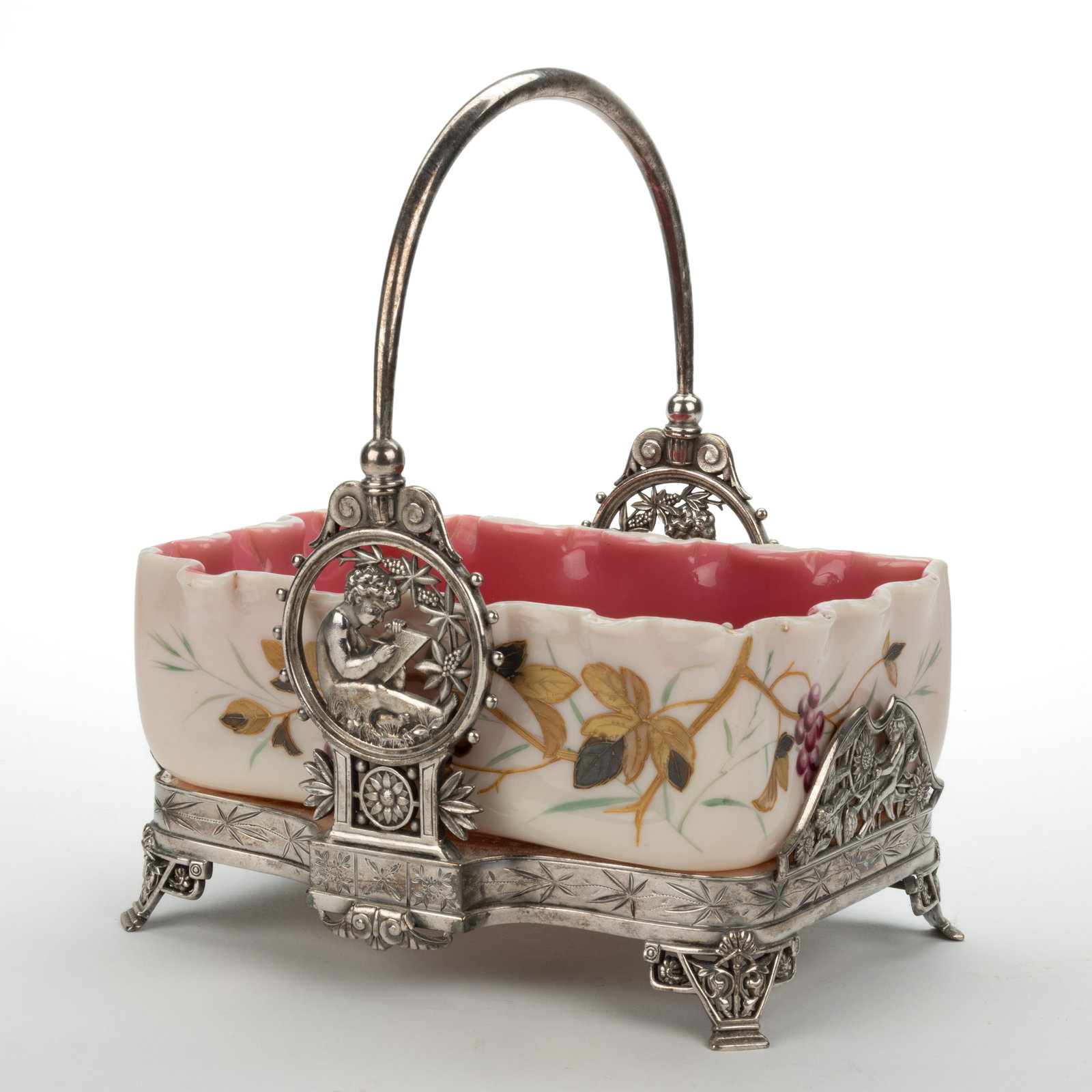 VICTORIAN CASED GLASS BRIDE'S BASKET: VICTORIAN CASED GLASS BRIDE'S BASKET, glossy opaque pink cased custard (reacts under black light), ruffled-rim rectangular form with polychrome-enamel and gilt foliate and cherry decoration, 