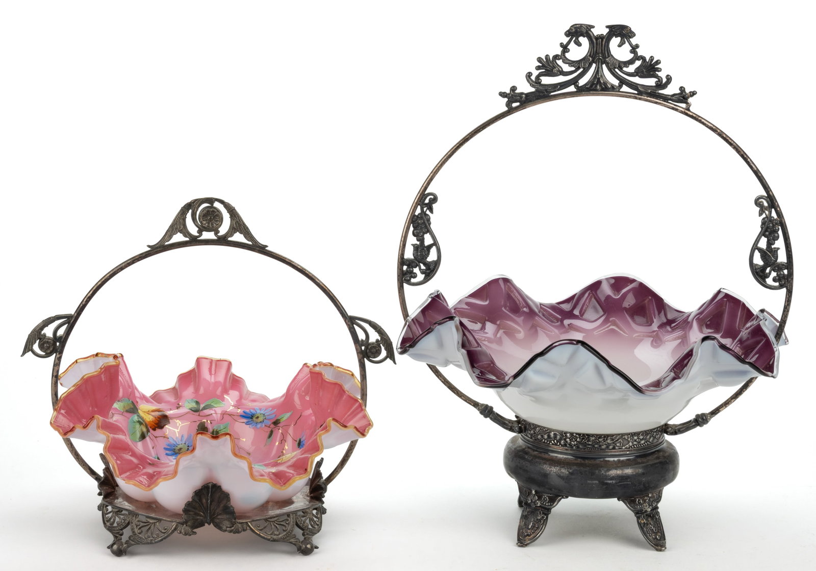 VICTORIAN CASED GLASS BRIDE'S BASKETS, LOT OF TWO: VICTORIAN CASED GLASS BRIDE'S BASKETS, LOT OF TWO, comprising a glossy shaded amethyst cased opaque white bowl with ruffled rim and diamond pattern fitted in a quadruple-plated stand mar
