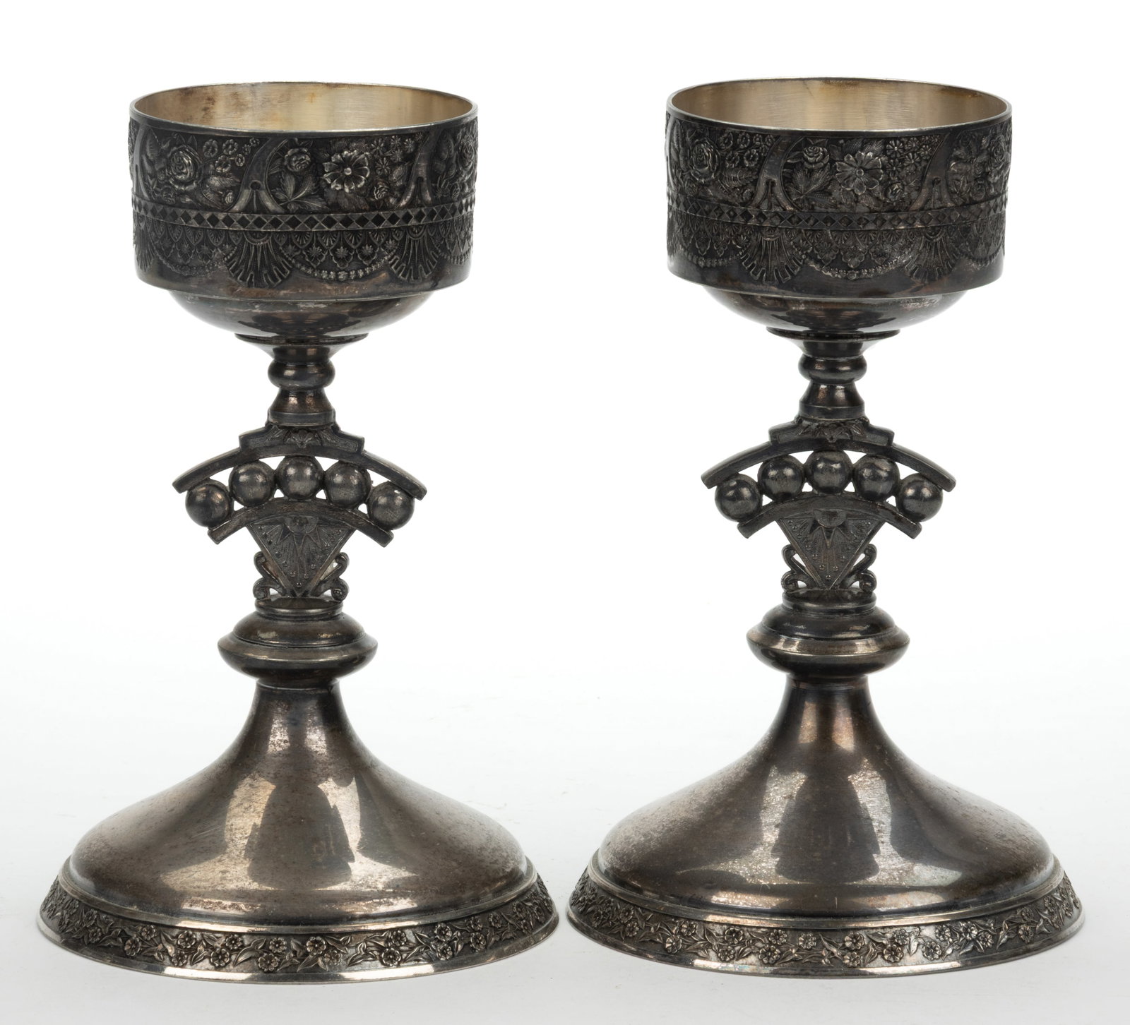 ROGERS & BRO. TRIPLE-PLATED VASE STANDS, PAIR: ROGERS & BRO. TRIPLE-PLATED VASE STANDS, PAIR, each having a round top with bas-relief decoration including flowers, raised on a stem with wedge-shaped center featuring beads and rayed starburst w