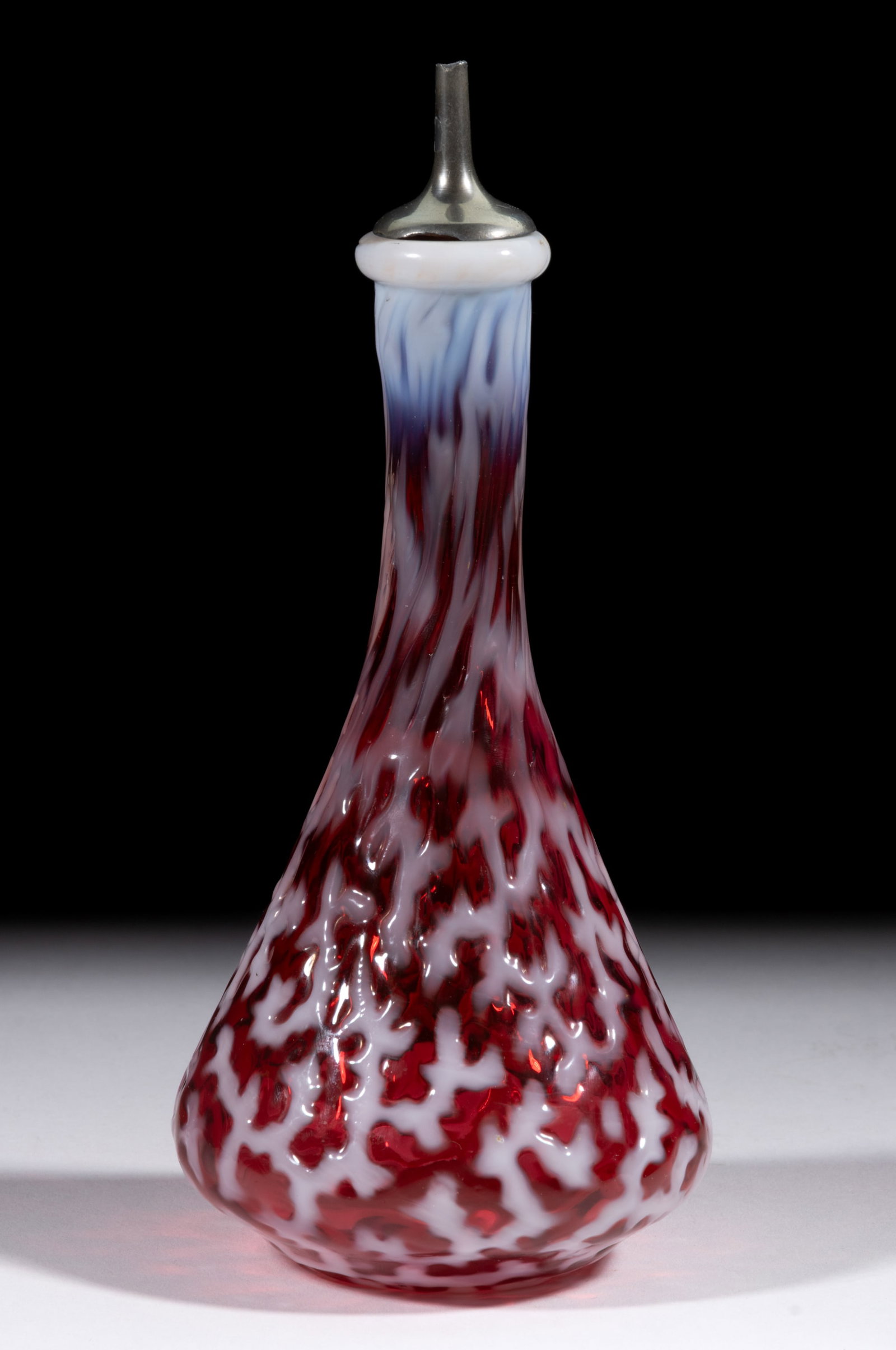 CORAL REEF BITTERS / BARBER'S BOTTLE: CORAL REEF BITTERS / BARBER'S BOTTLE, cranberry opalescent, tapered form with metal and cork spout and polished pontil mark. Hobbs, Brockunier & Co. Late 19th/early 20th century. 8 1/2&qu