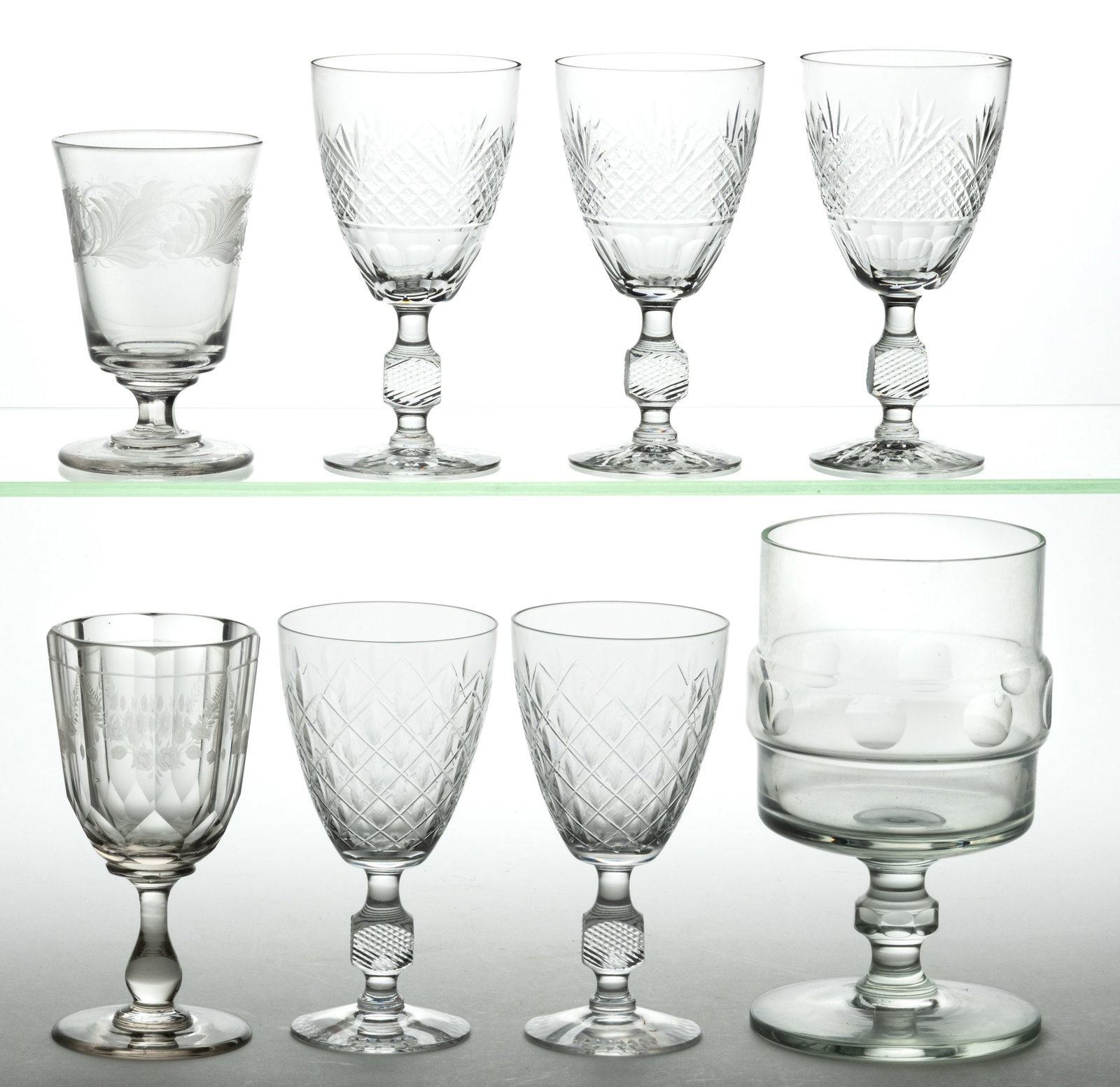 ASSORTED CUT AND ENGRAVED GLASS DRINKING ARTICLES, LOT OF EIGHT: ASSORTED CUT AND ENGRAVED GLASS DRINKING ARTICLES, LOT OF EIGHT, colorless, including three goblets with cut fan and diamond detailing and faucet cut base with a square knop on stem, one short sq