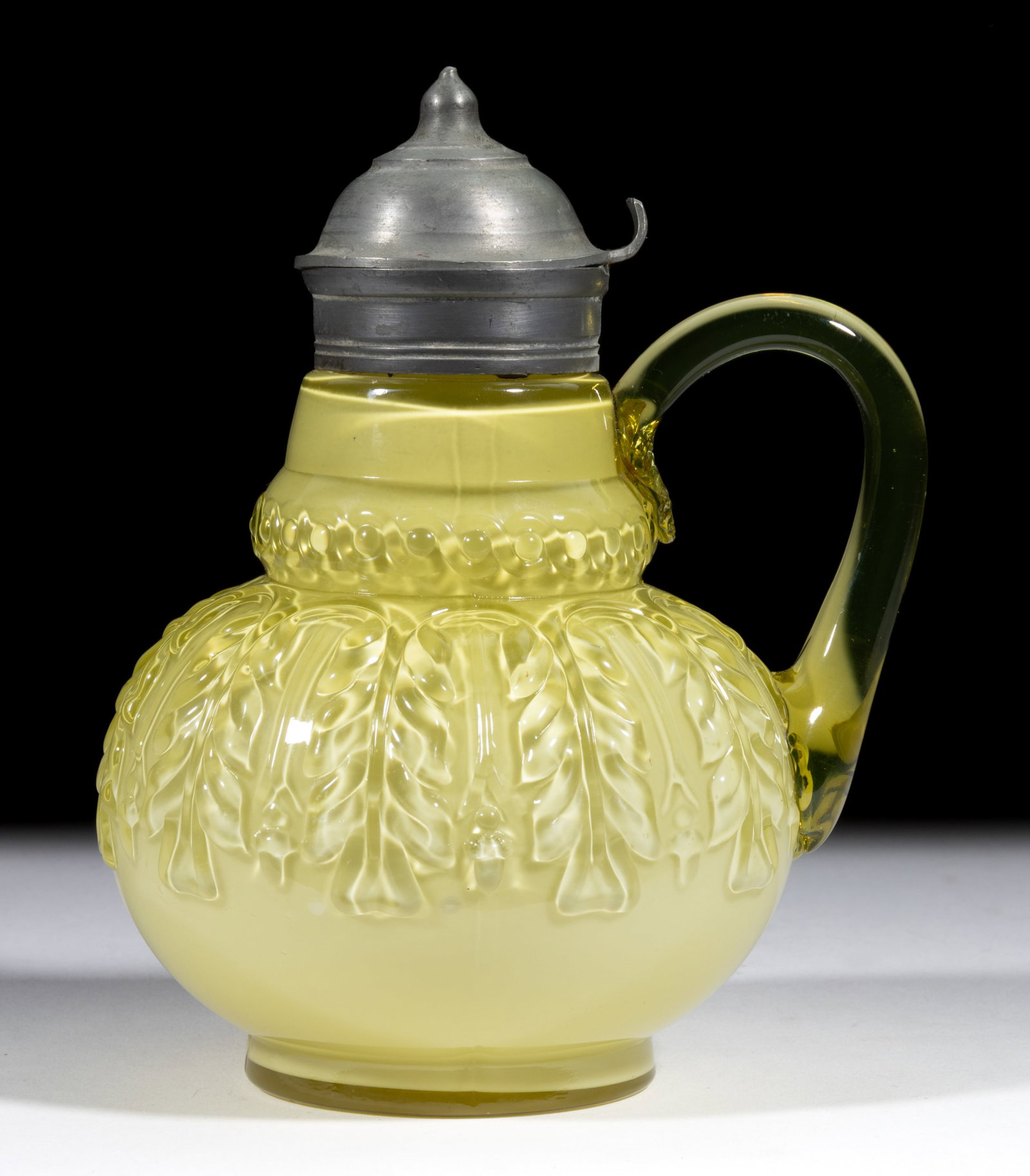 NORTHWOOD NO. 263 / LEAF UMBRELLA SYRUP PITCHER: NORTHWOOD NO. 263 / LEAF UMBRELLA SYRUP PITCHER, Topaz, applied topaz handle with a pressed feather design to the upper terminal of the handle, period lid. H. Northwood Glass Co. Pattern introduced in