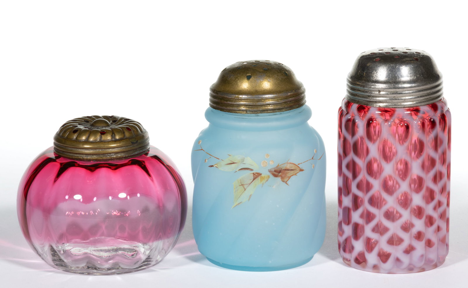 ASSORTED VICTORIAN GLASS SUGAR SHAKERS, LOT OF THREE: ASSORTED VICTORIAN GLASS SUGAR SHAKERS, LOT OF THREE, blue, rubina, cranberry, comprising one Northwood Parian Swirl satin finish shaker with enamel floral decoration, one Ribbed Opal Lattice shaker, 