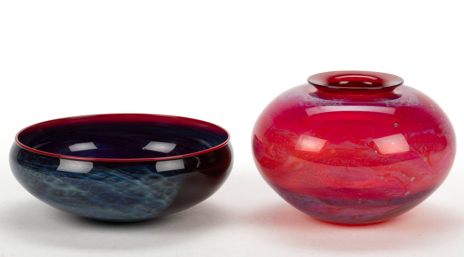 JOSH SIMPSON (B.1949) STUDIO ART GLASS ARTICLES, LOT OF TWO: JOSH SIMPSON (B.1949) STUDIO ART GLASS ARTICLES, LOT OF TWO, comprising one "New Mexico" bowl with mottled colors, with blue being prominent, applied ruby red rim, polished base, signed &quo