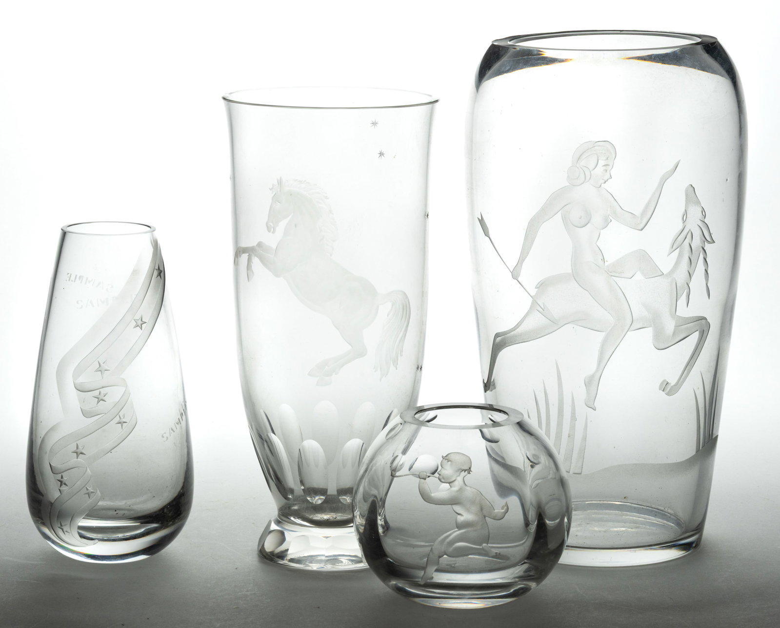 ASSORTED 20TH CENTURY ENGRAVED ART GLASS VASES, LOT OF FOUR: ASSORTED 20TH CENTURY ENGRAVED ART GLASS VASES, LOT OF FOUR, colorless, including a spherical vase featuring a boy blowing bubbles and an oblong vase featuring Diana the Huntress riding on a