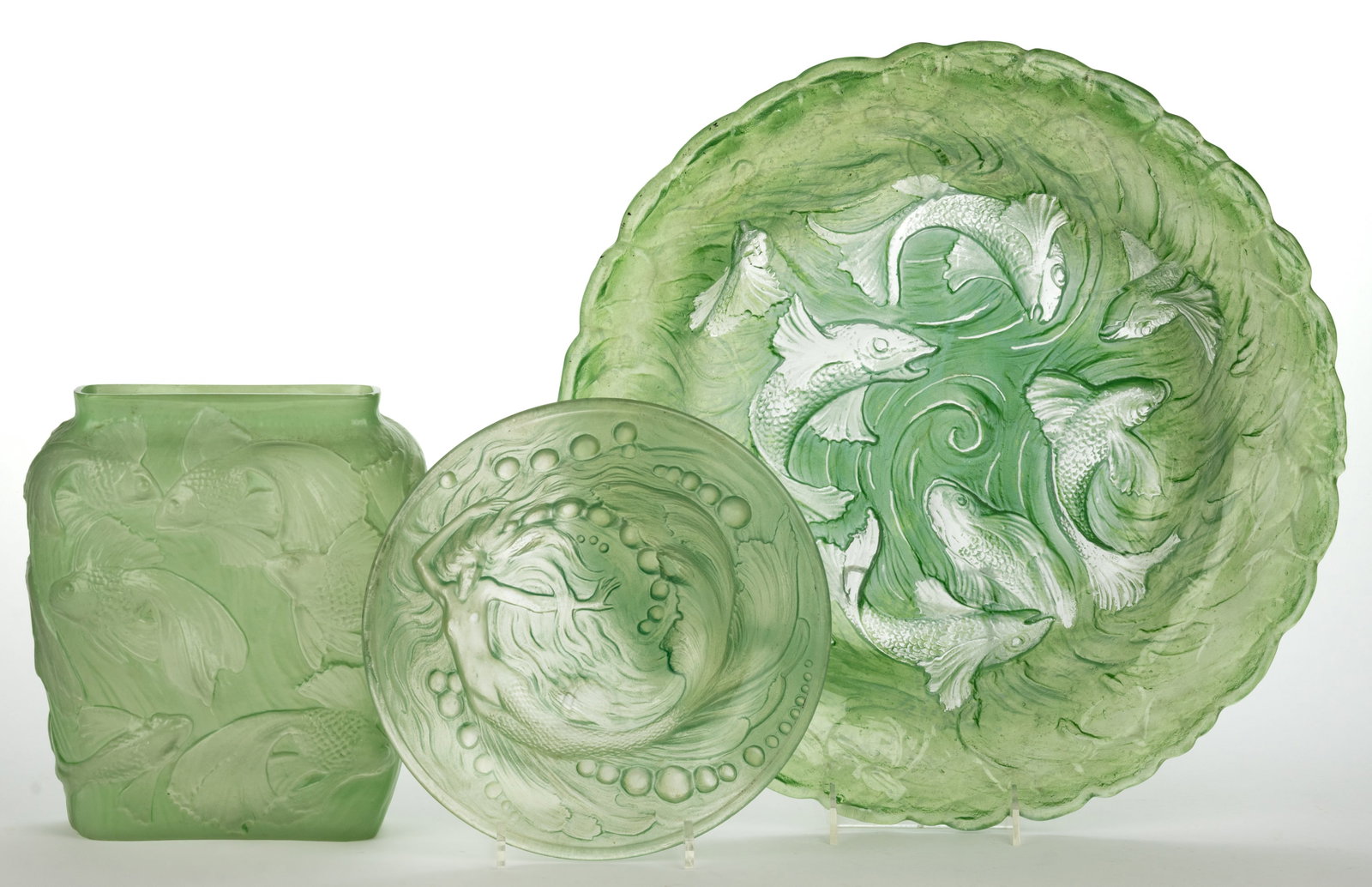 CONSOLIDATED ART GLASS AQUATIC MOTIF ARTICLES, LOT OF THREE: CONSOLIDATED ART GLASS AQUATIC MOTIF ARTICLES, LOT OF THREE, colorless with green wash and frosted design, comprising a Fish bowl, a Mermaid bowl, and a Tropical Fish vase. Consolidated Lamp