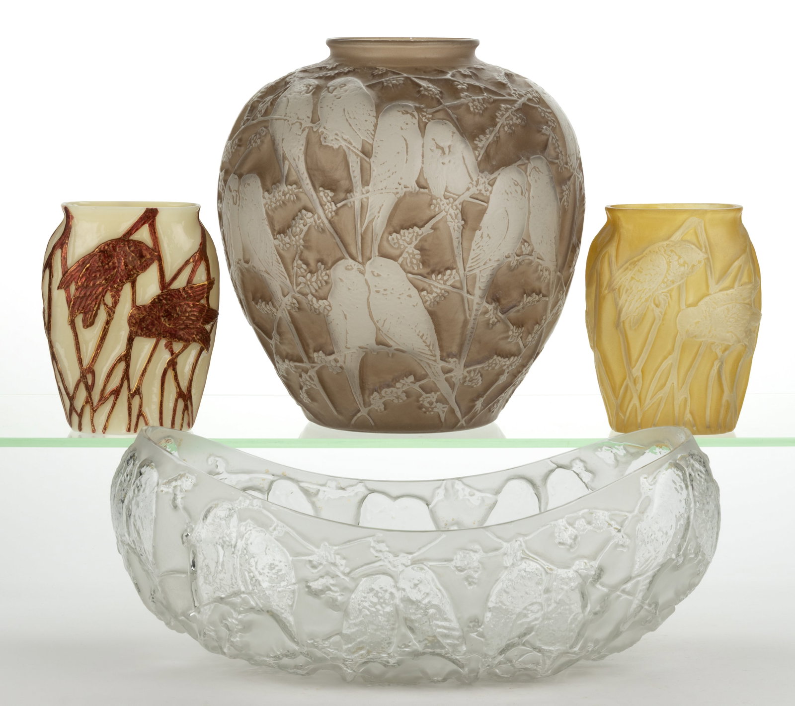 CONSOLIDATED ART GLASS BIRD MOTIF ARTICLES, LOT OF FOUR: CONSOLIDATED ART GLASS BIRD MOTIF ARTICLES, LOT OF FOUR, colorless and frost, tan and sepia washes, and custard (reacts under black light) with red decoration, comprising two Screech Owls vases, 