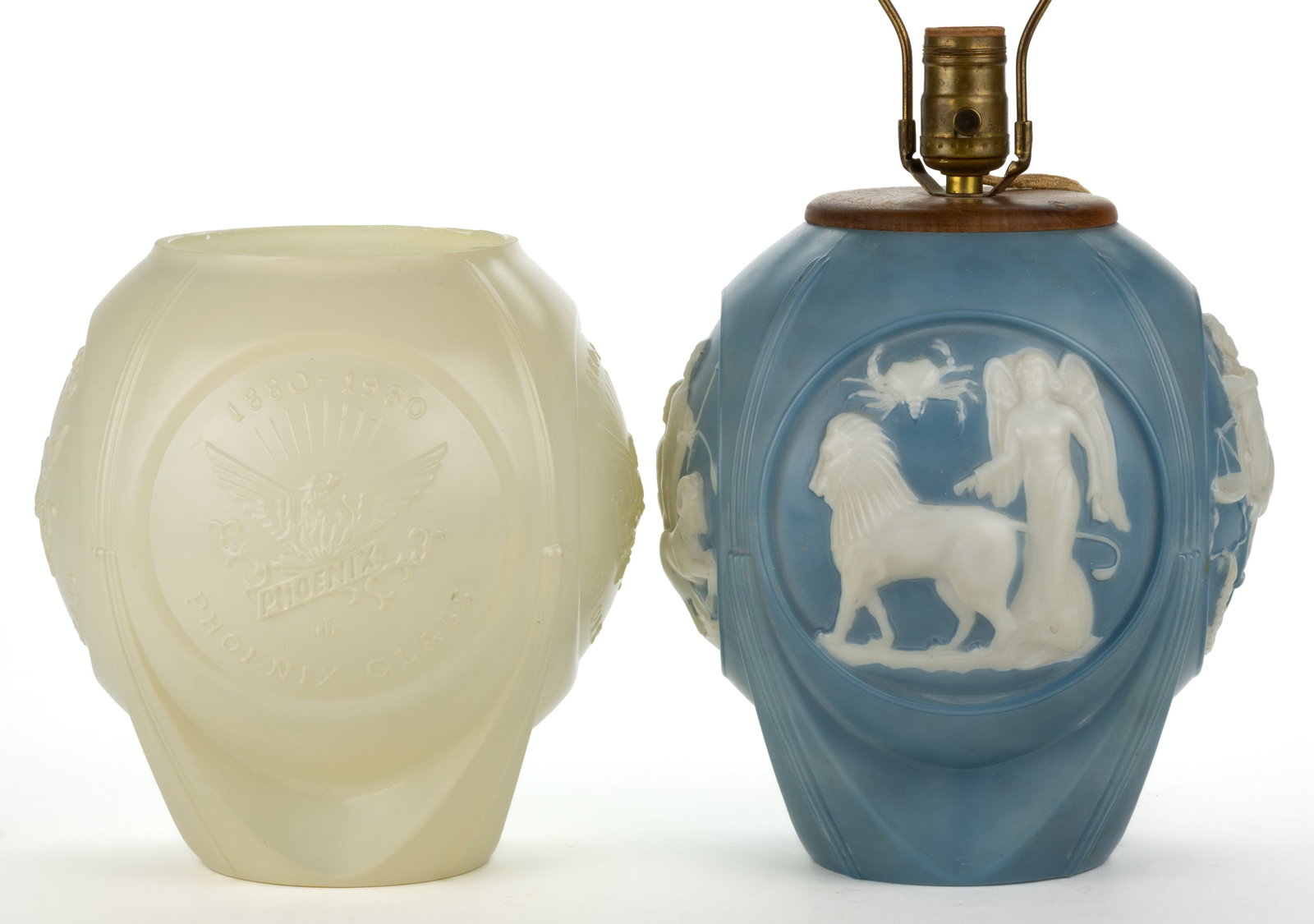 PHOENIX ART GLASS ARTICLES, LOT OF TWO: PHOENIX ART GLASS ARTICLES, LOT OF TWO, comprising a medium blue over opaque white Zodiac lamp and an ivory 100th anniversary vase. Lamp currently in working condition. Phoenix Glass Co