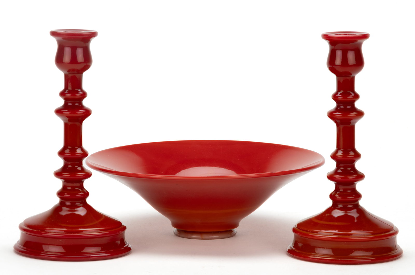 NORTHWOOD CHINESE CORAL GLASS ARTICLES, LOT OF THREE: NORTHWOOD CHINESE CORAL GLASS ARTICLES, LOT OF THREE, comprising a pair of no. 708 spindle candlesticks and a no. 692 bowl, embossed to the interior base "CITIZENS MUTUAL TRUST CO. / 1924 / 
