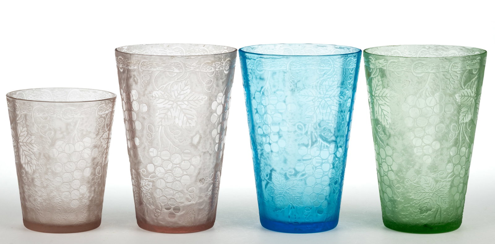 FOSTORIA GRAPE BROCADE ETCHED GLASS VASES, LOT OF FOUR: FOSTORIA GRAPE BROCADE ETCHED GLASS VASES, LOT OF FOUR, blue, pink, and apple green (reacts under black light), each tapered form. Circa 1927. 6" and 8" H. Provenance: Th