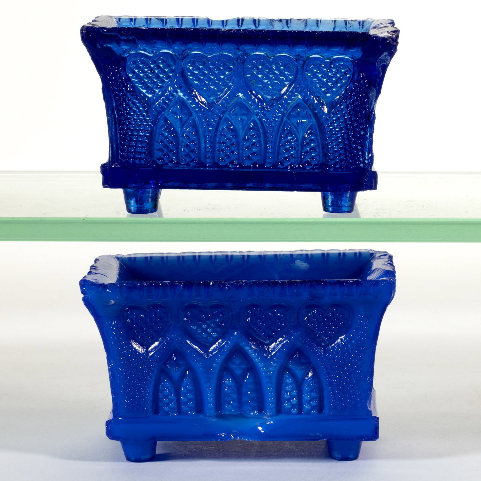 GA-4A GOTHIC ARCH AND HEART PRESSED OPEN SALTS, LOT OF TWO: GA-4A GOTHIC ARCH AND HEART PRESSED OPEN SALTS, LOT OF TWO, opalescent medium blue with mottling and medium blue, even-scallop rims, raised on bucket-like feet. Scarce and rare. Probably Boston &