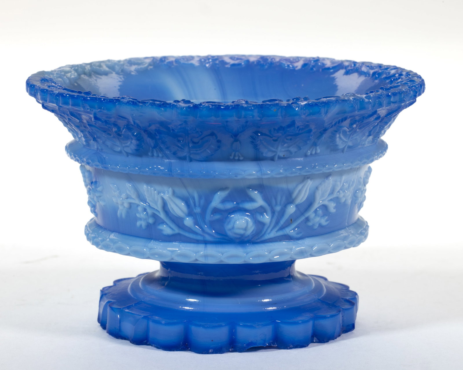 RP-2 ROUND FLORAL PRESSED OPEN SALT: RP-2 ROUND FLORAL PRESSED OPEN SALT, mottled opaque powder blue to violet blue, intricate foliate chain within the even-scallop rim, 19-scallop foot. Extremely rare. Boston & Sandwich Glass Co. 18
