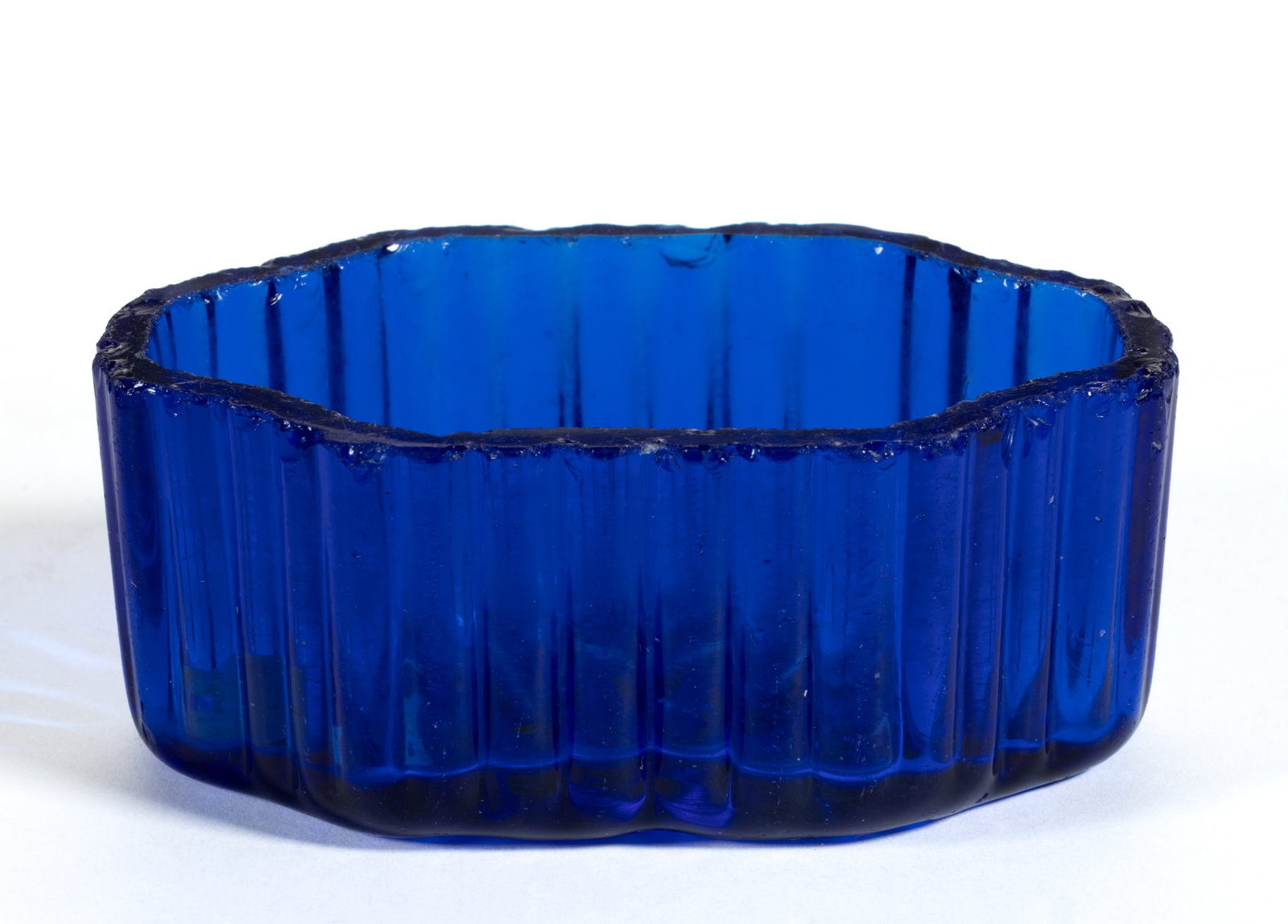 BLOW-OVER AND CRACK-OFF OBLONG OPEN SALT: BLOW-OVER AND CRACK-OFF OBLONG OPEN SALT, deep sapphire blue, molded with vertical ribs on exterior sides and an eight-point star under the base, factory ground and polished flat rim. Extremely